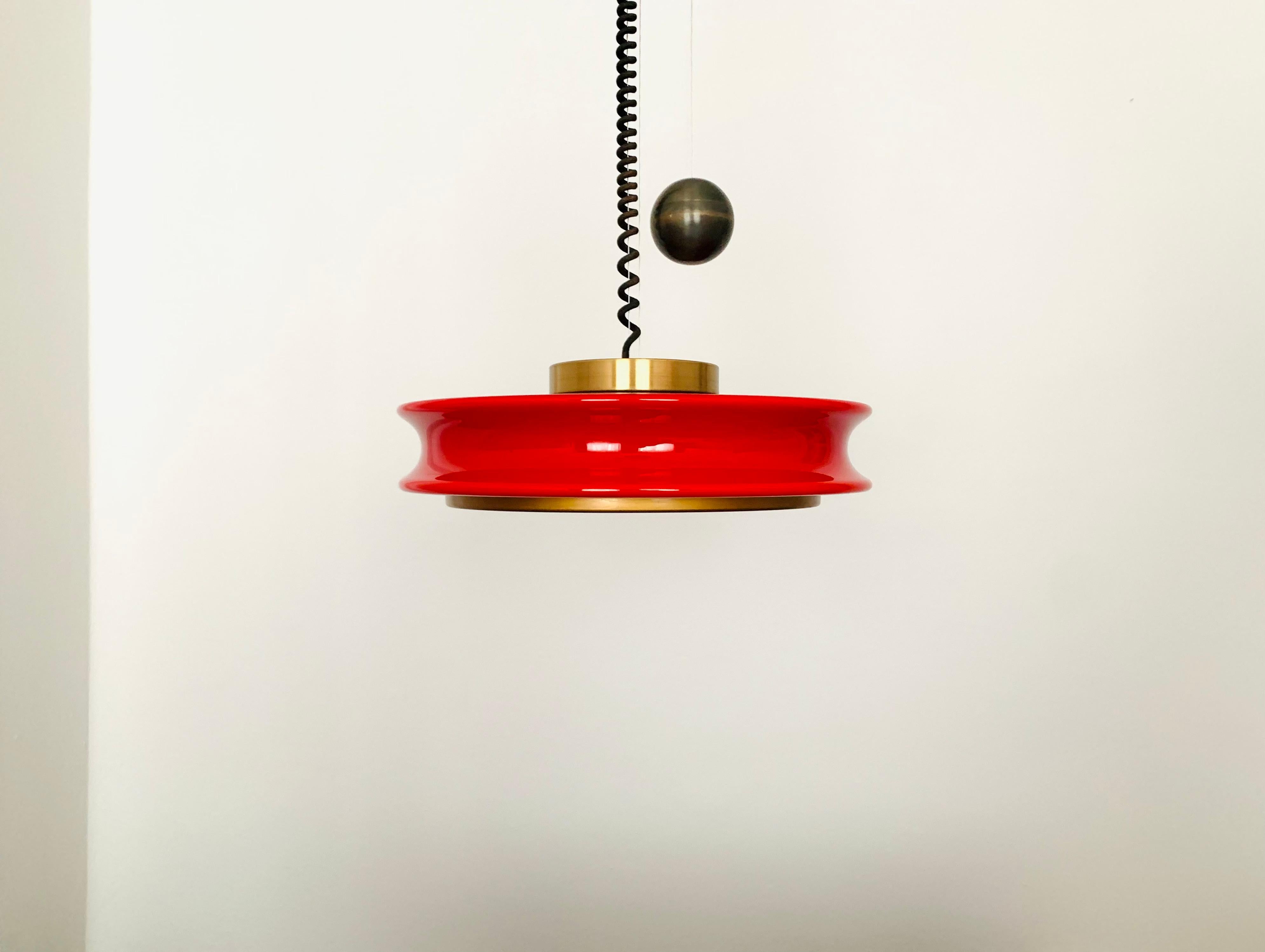 Extremely impressive Orion pendant lamp from the 1960s.
Very unusual design and a real highlight for every design lover.
The lighting effect of the lamp is extremely beautiful.
The red glass has an exceptionally beautiful colour.
Very high