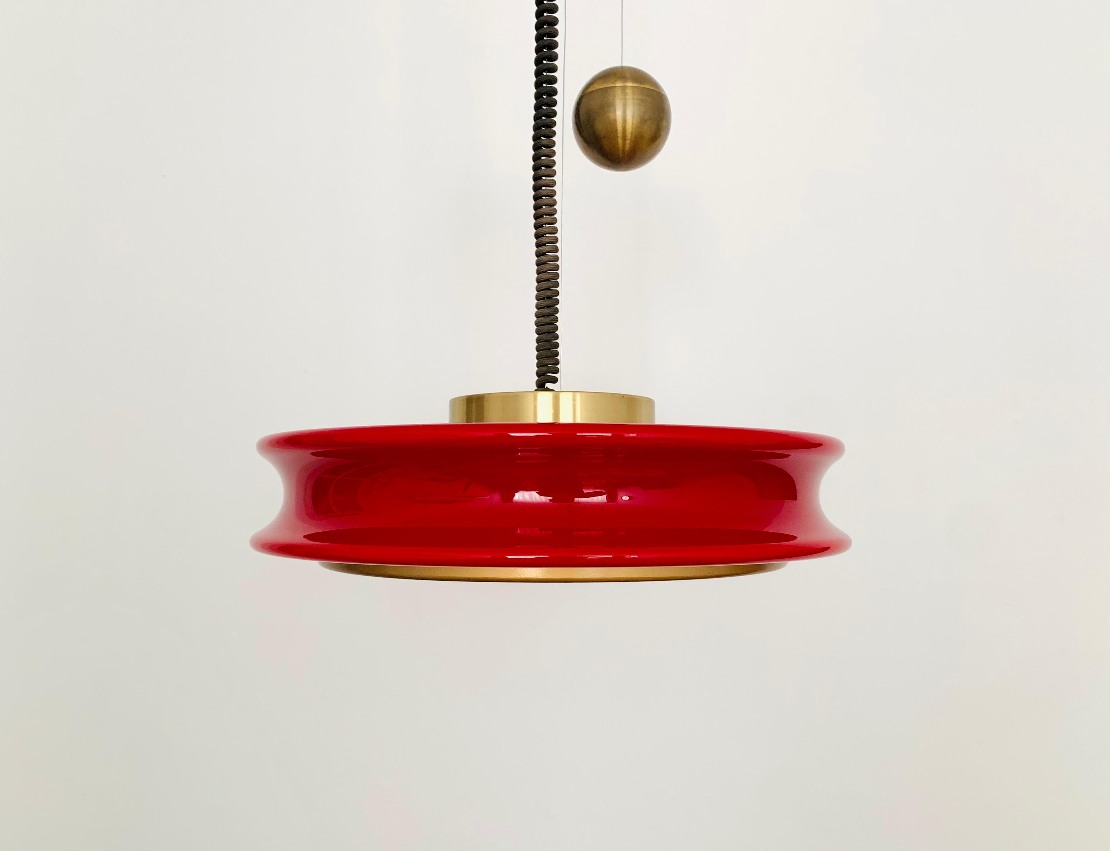 Extremely impressive Orion pendant lamp from the 1960s.
Exceptional design and a real highlight for every design lover.
The lighting effect of the lamp is extremely beautiful.
The red glass has an exceptionally beautiful color.
Very high quality