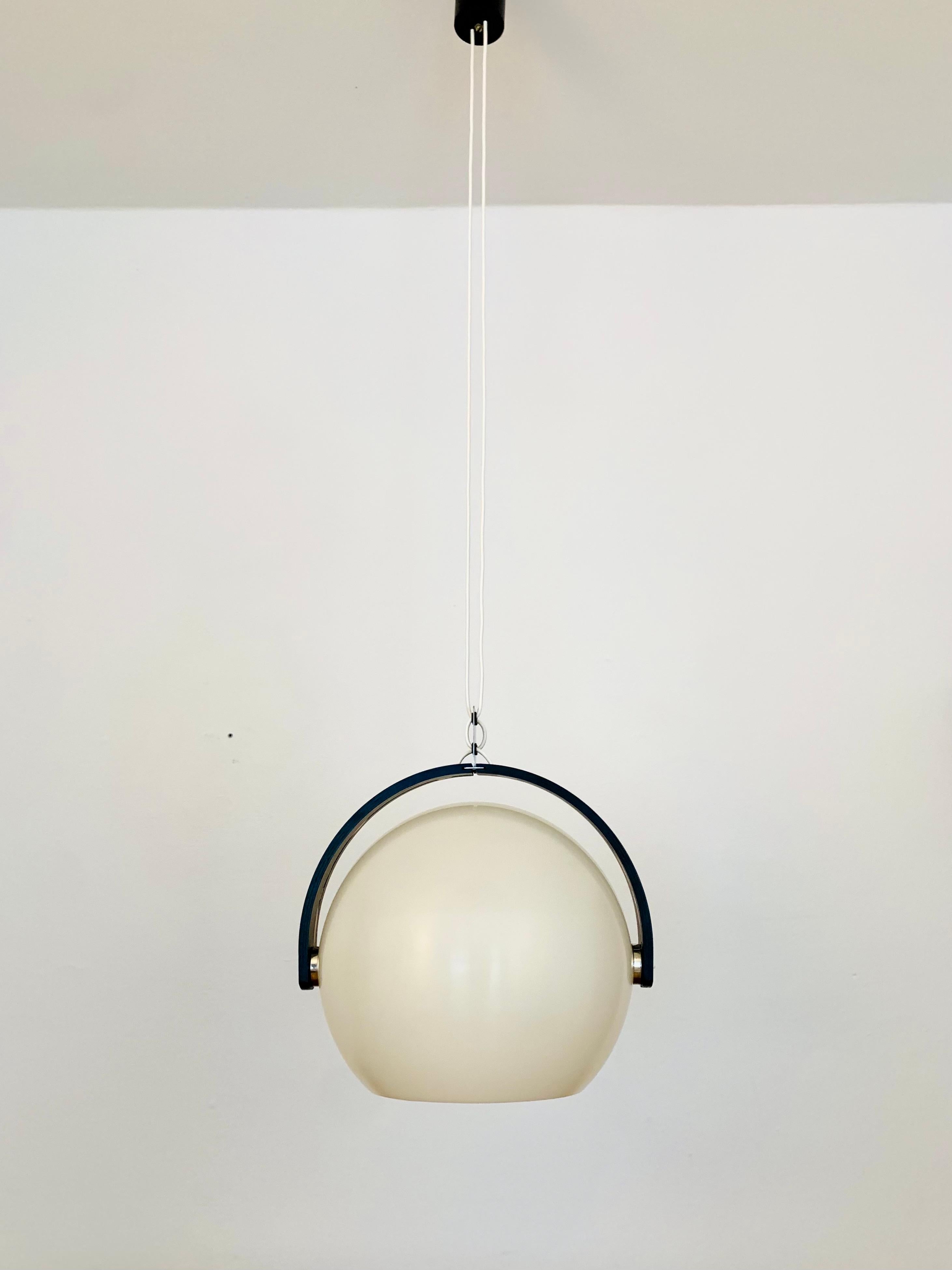 Beautiful pendant lamp from the 1960s.
Great and unusual design with a fantastically comfortable look.
Very nice curved wood details and high quality workmanship.
A cozy play of light is created.
The lampshade is adjustable.

Manufacturer:
