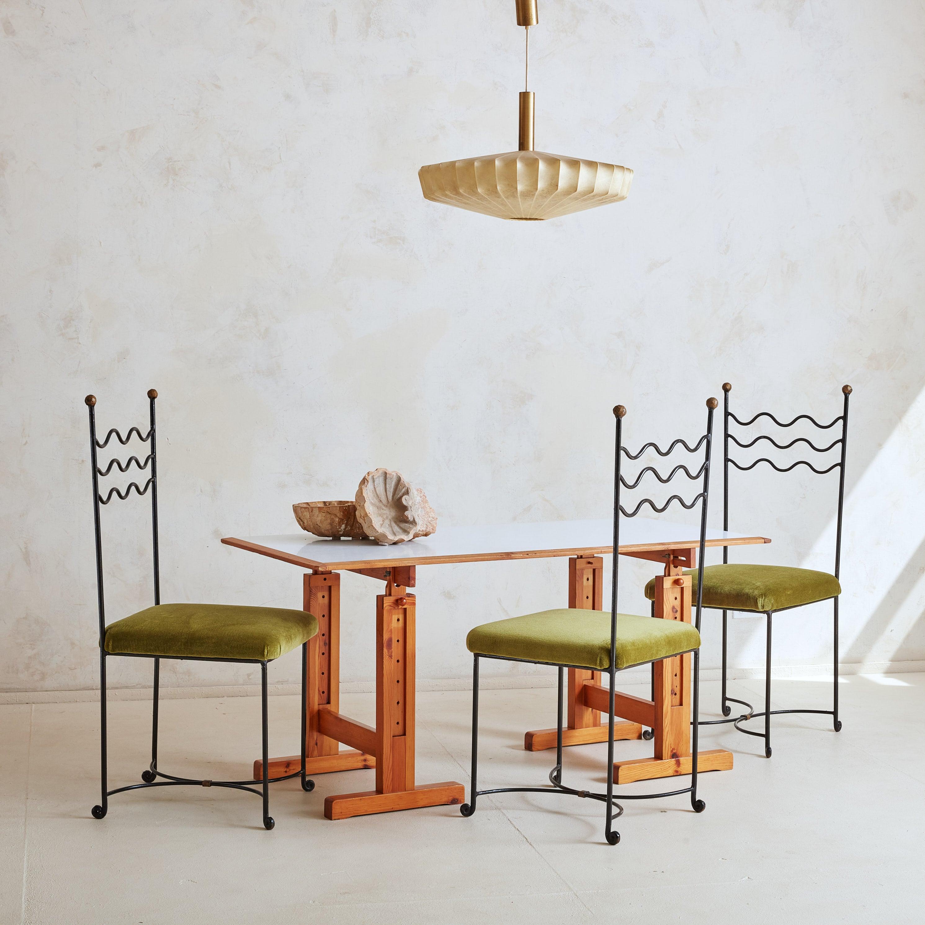 A 1970s architectural desk or dining table attributed to Ole Pira & Kurt Hafeli for Laukaan Puu. This Mid-Century Modern piece features an angular pine wood base with rectangular block legs, wide feet, and stretcher accents. Each leg is adjustable,
