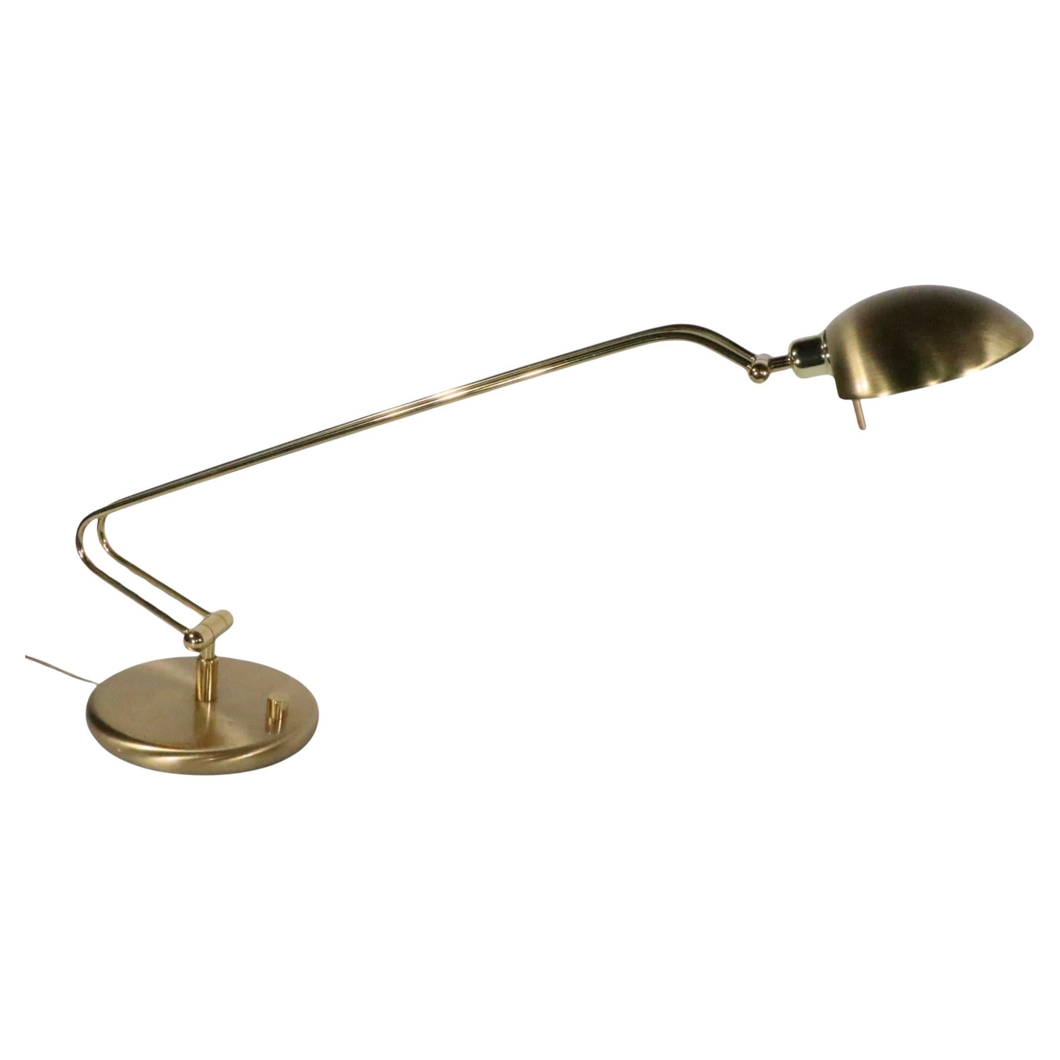 Exceptional Post-Modern style desk lamp by noted German maker Holtkotter, circa 1980's. The lamp features several adjustments, including a swivel  and tilt point at the base, as well as one at the joint between the hood shade and the arm.  In