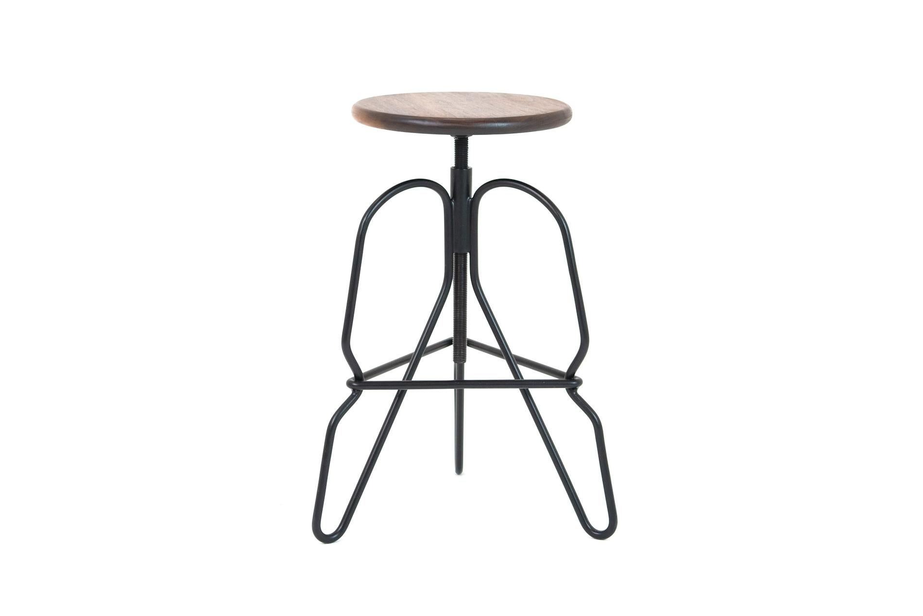 The rig stool is a minimal solid steel stool featuring an adjustable solid wood seat on a threaded rod. The legs are tied together with a triangular footrest.

This handcrafted piece is hand-oiled using our in-house oils and techniques and