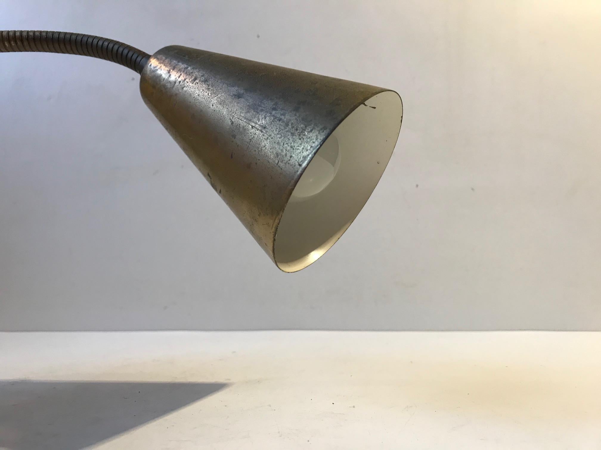 Fully adjustable wall lamp made from solid brass. It was manufactured and designed by E. S. Horn in Denmark during the mid-late 1950s. It has a great honest patina all over. In style it is reminiscent to designs by Paavo Tynell and Vilhelm Lauritzen.