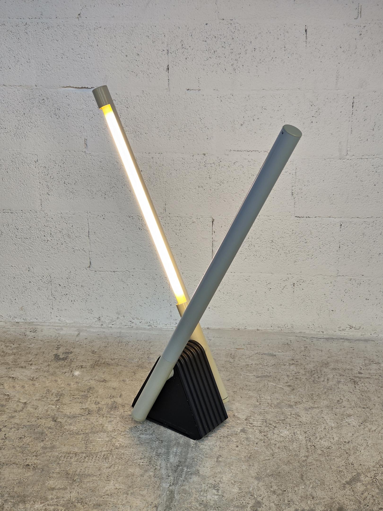 Beautiful adjustable Sistema Flu lamp designed by Rodolfo Bonetto for Luci Italia 1980s. 
This lamp can be used as floor, wall or ceiling lamp. 
It has a black triangular base and two gray adjustable arms.
The arms can rotate to about 180 degrees