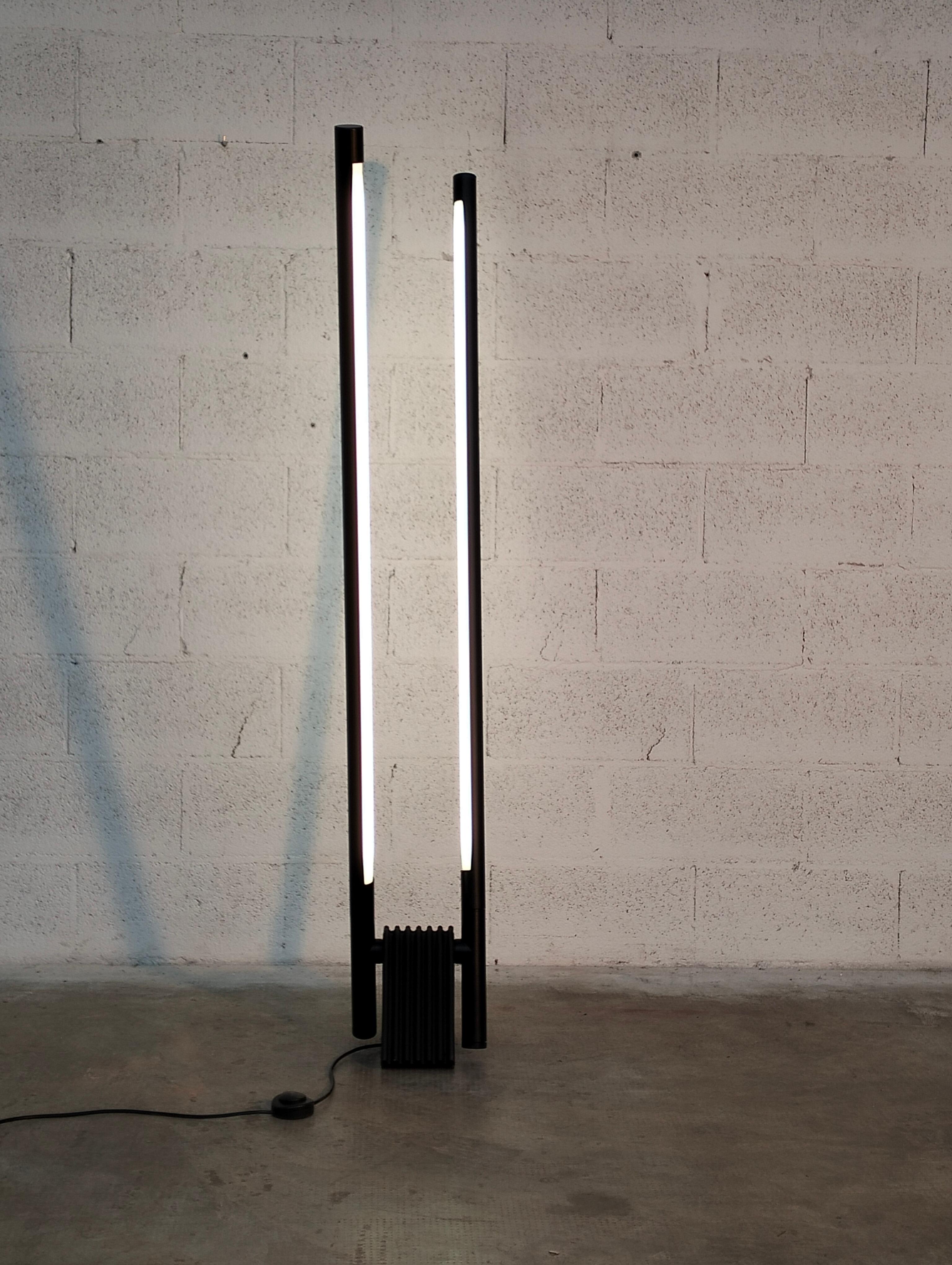Adjustable Sistema Flu Lamp by Rodolfo Bonetto for Luci 80s

Floor lamp mod. Sistema Flu with triangular base in black plastic. The two neo lights are adjustable and have a cylindrical structure in black painted metal.
Produced by Luci Italia in