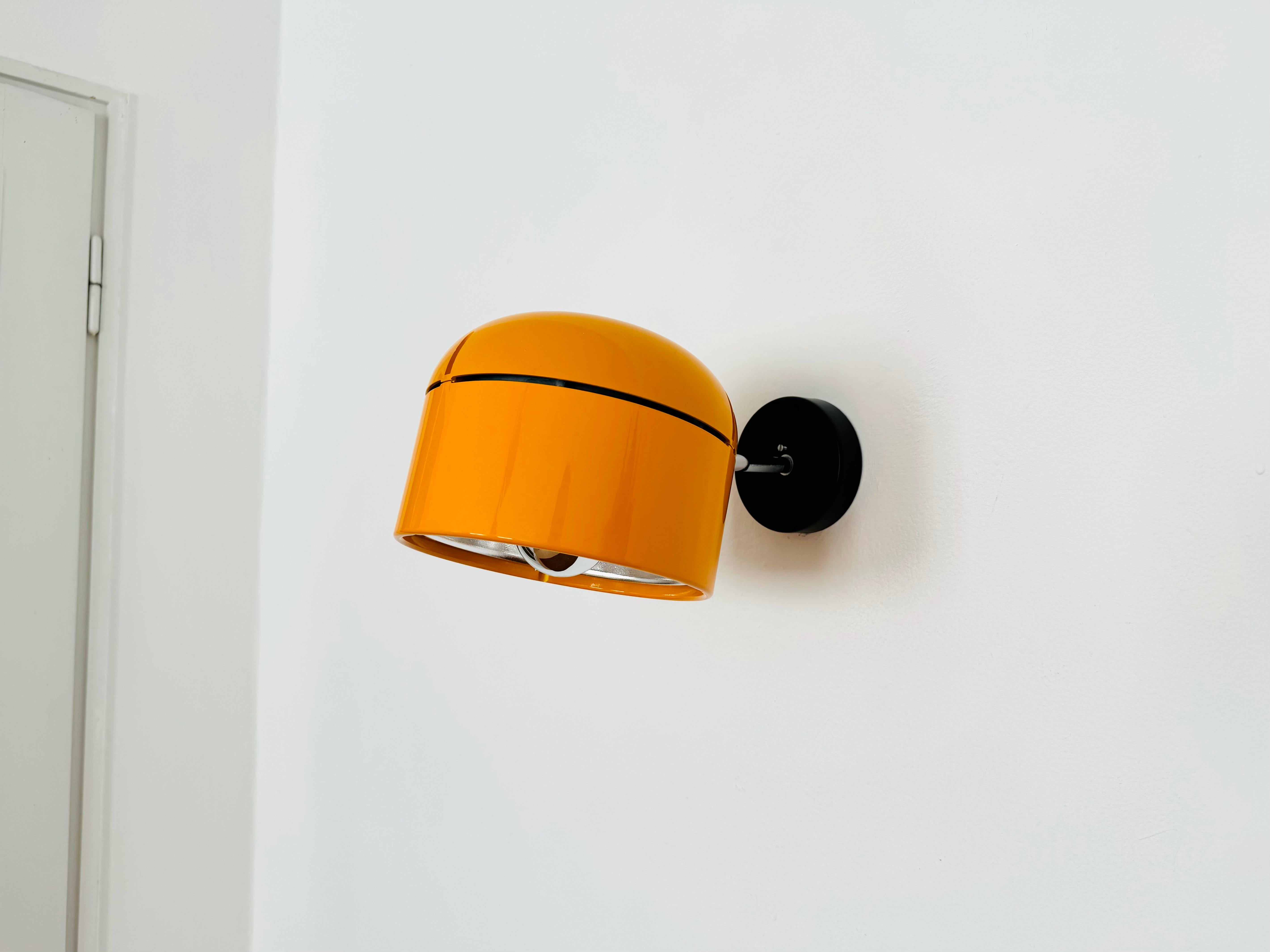 Fantastic lamp for wall or ceiling mounting from the 1970s.
The Staff brand is known for its high-quality workmanship and perfectionist design.
The large yellow-orange lamp head is infinitely adjustable.
The mirror reflector creates a focused light