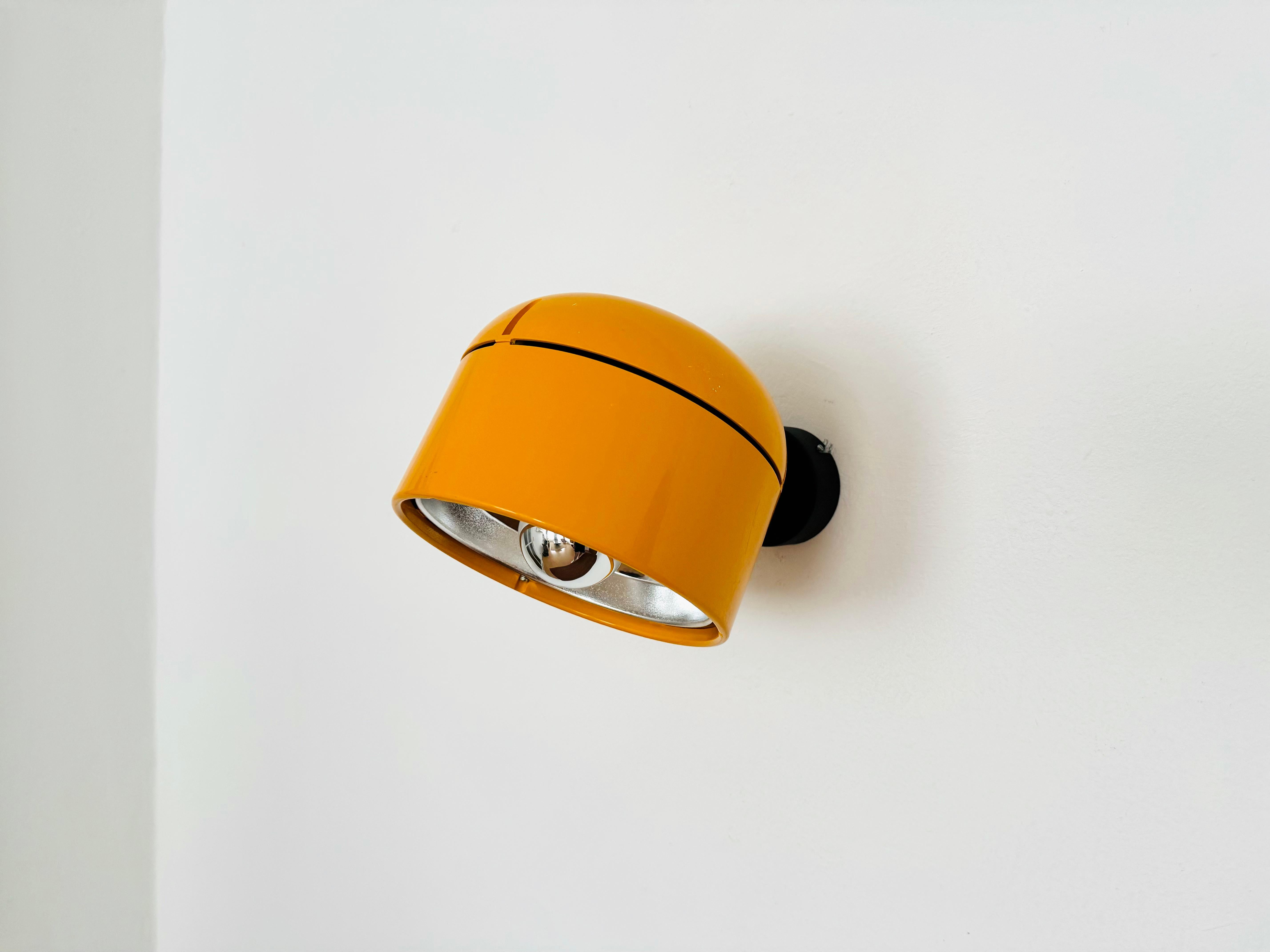 Fantastic lamp for wall or ceiling mounting from the 1970s.
The Staff brand is known for its high-quality workmanship and perfectionist design.
The large yellow-orange lamp head is infinitely adjustable.
The mirror reflector creates a focused light