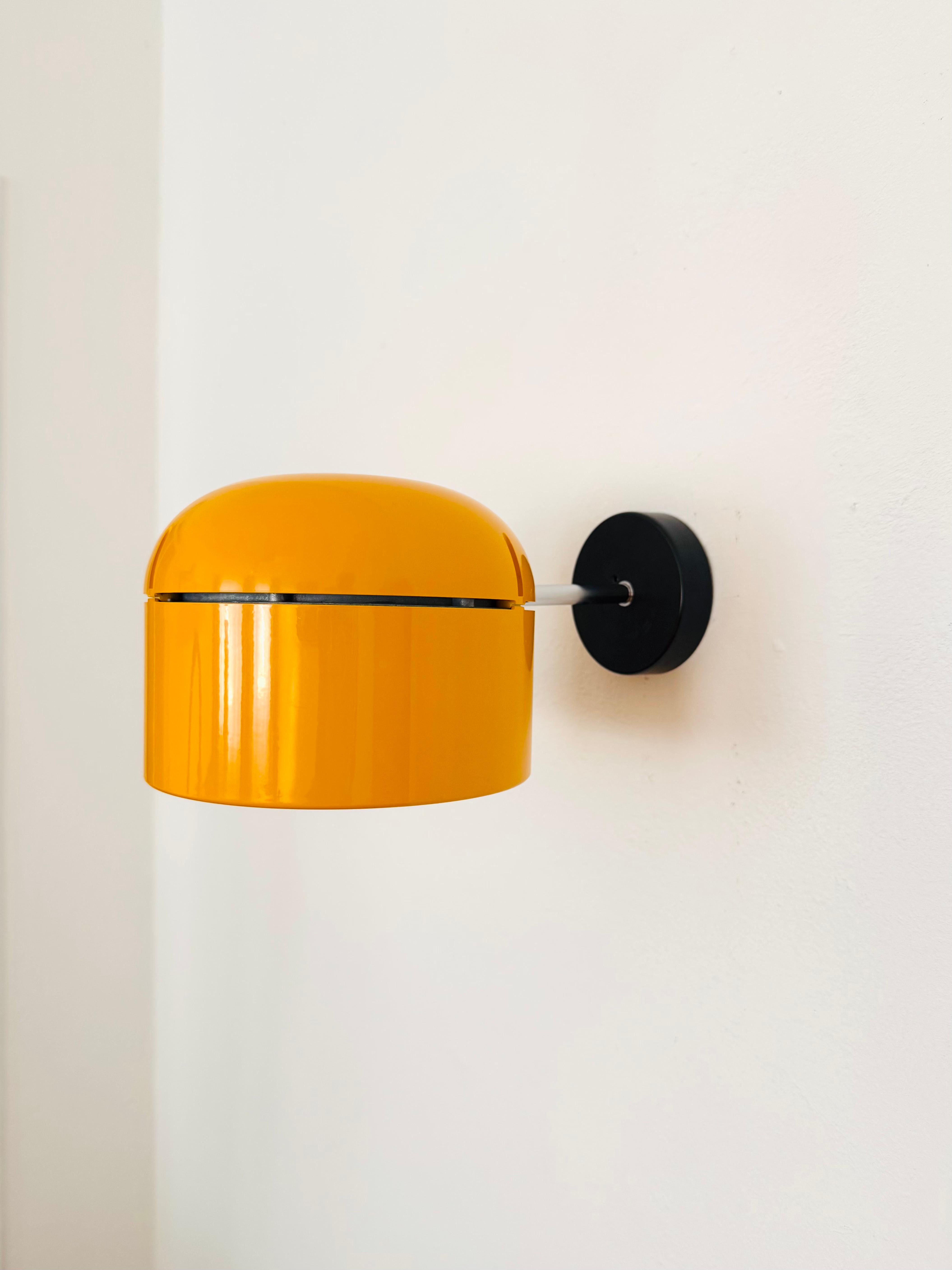 Fantastic lamp for wall or ceiling mounting from the 1970s.
The Staff brand is known for its high-quality workmanship and perfectionist design.
The large yellow-orange lamp head is continuously adjustable.
The mirror reflector creates a concentrated