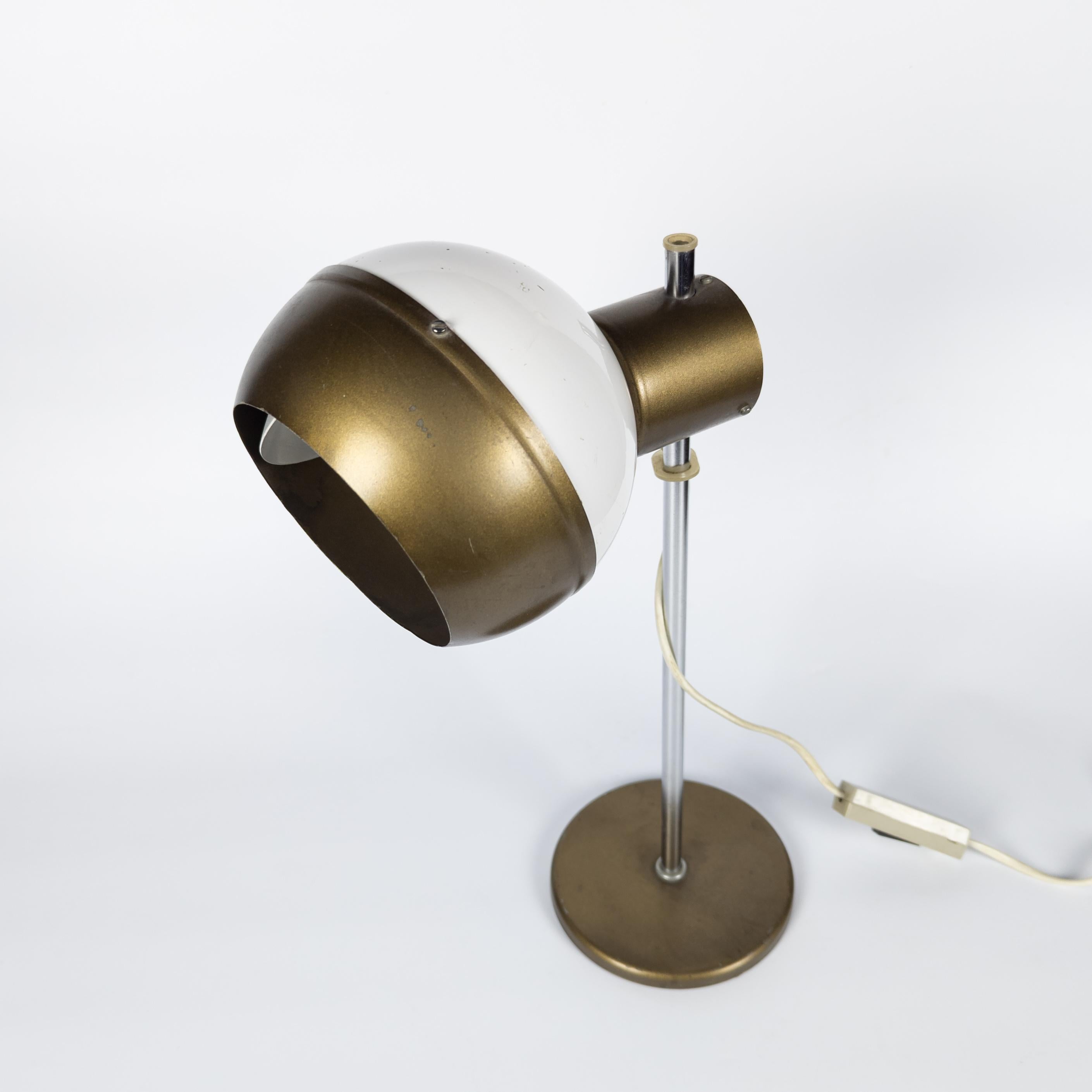 Adjustable space age lamp manufactured by Drukov, former Czechoslovakia in 1970's. Made of white and gold lacquered metal. The shade is held to the structure by means of a magnet and can be positioned in different ways. Manually dimmable using the