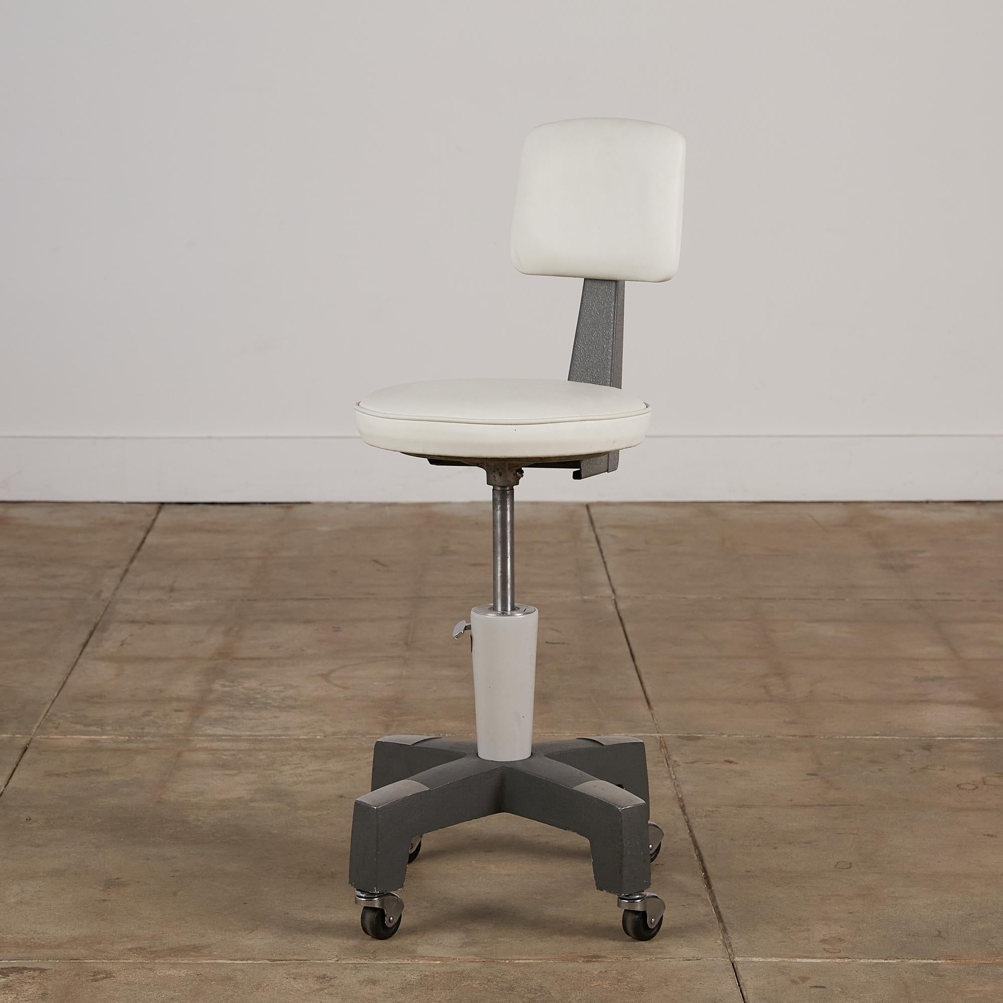 Adjustable stool by American Optical Corp. These stools were given as promotional items to opticians who used American Optical lenses in the glasses they prescribed to patients. It has been restored, with the metal polished and a newly upholstered