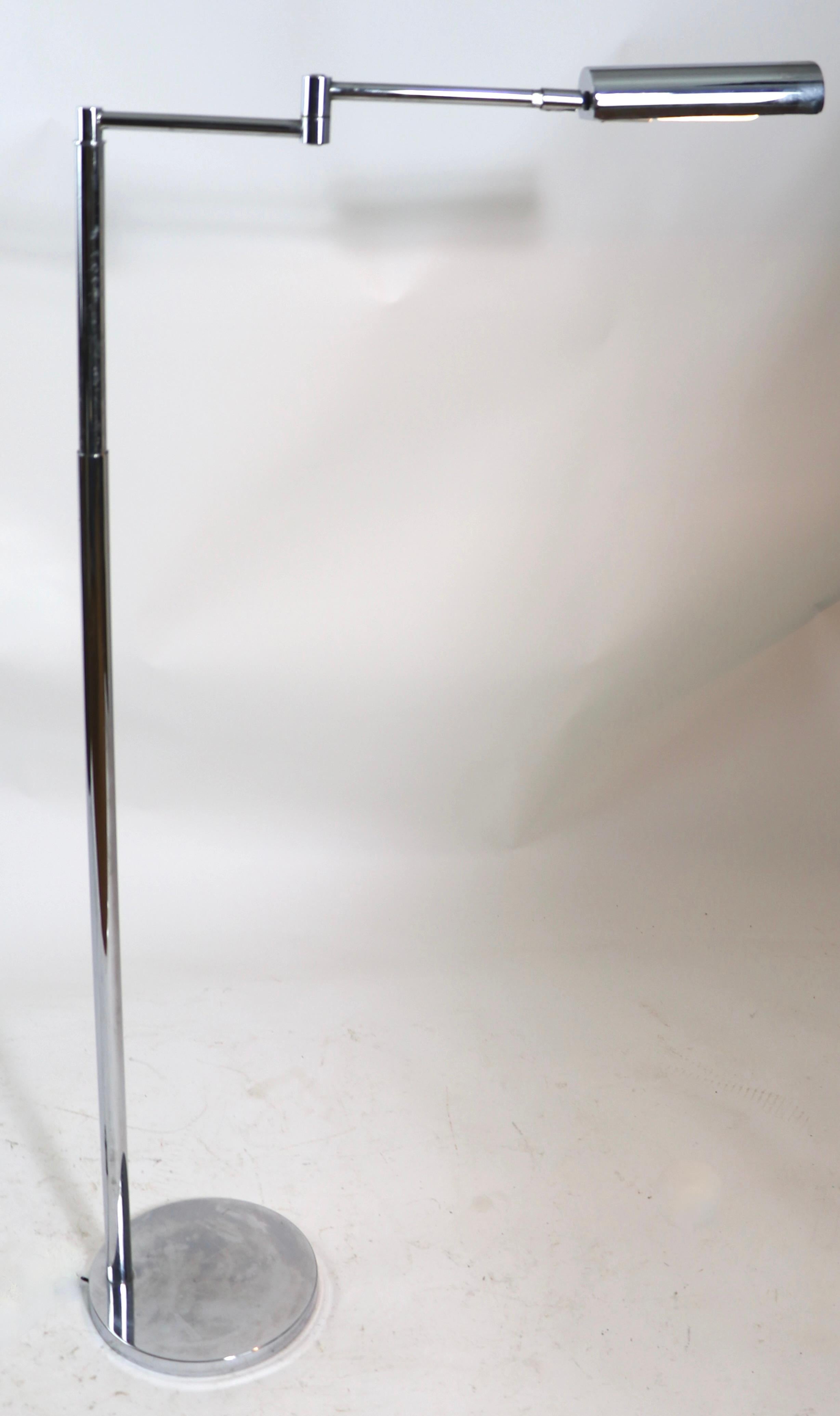 Classic modernist pharmacy model floor lamp made in Germany by Koch & Lowy, marked OGI. The lamp features several adjustments, it has a flex swing arm, each section of which is 8 in. L, and the chrome hood shade tilts to direct the light.
 The