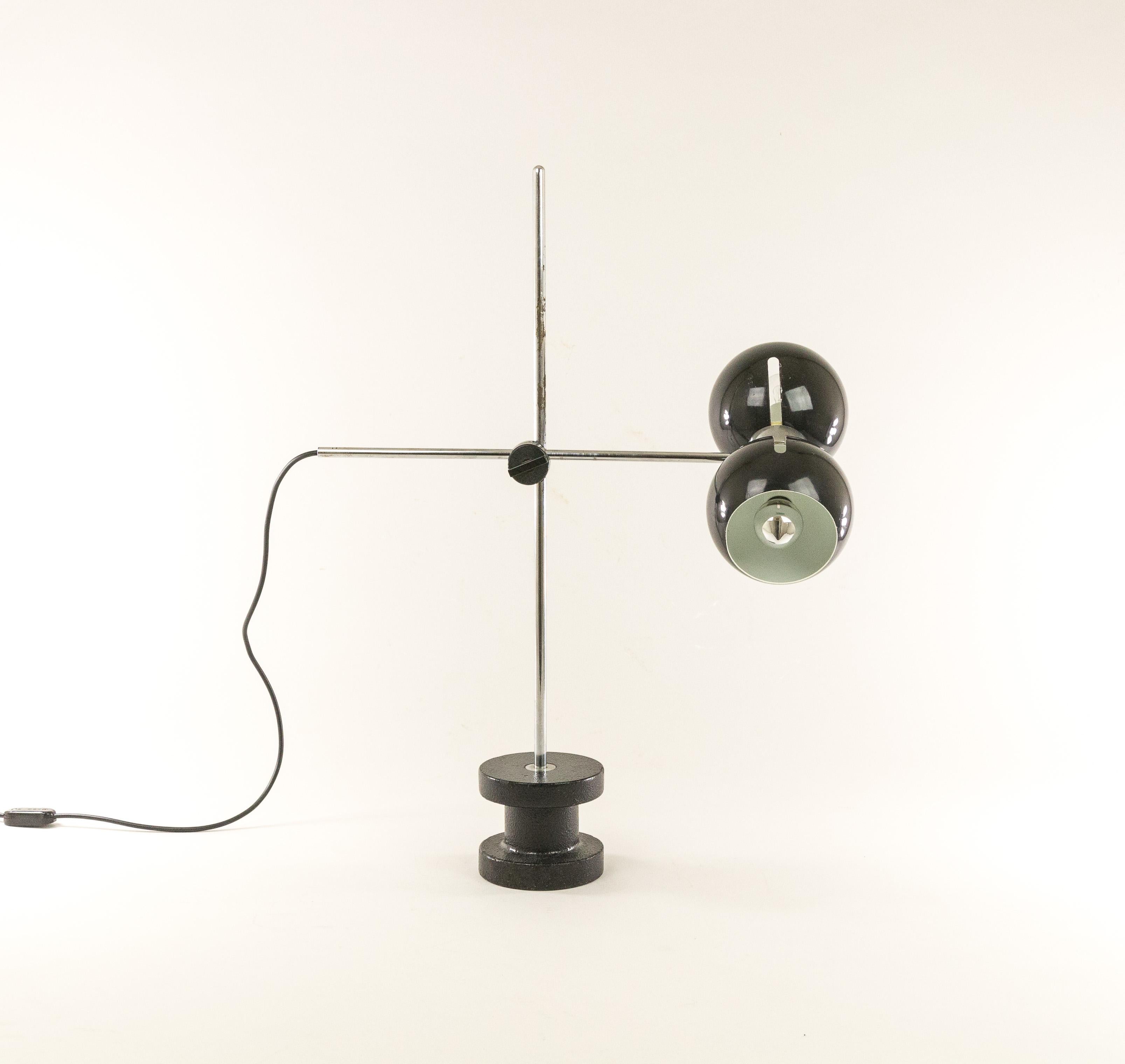 Fully adjustable table lamp manufactured by Italian lighting specialist Valenti, probably in the 1970s.

By loosening the black rotary knob, the position of the swivel arm can be changed. In addition, the black caps can also be turned in all