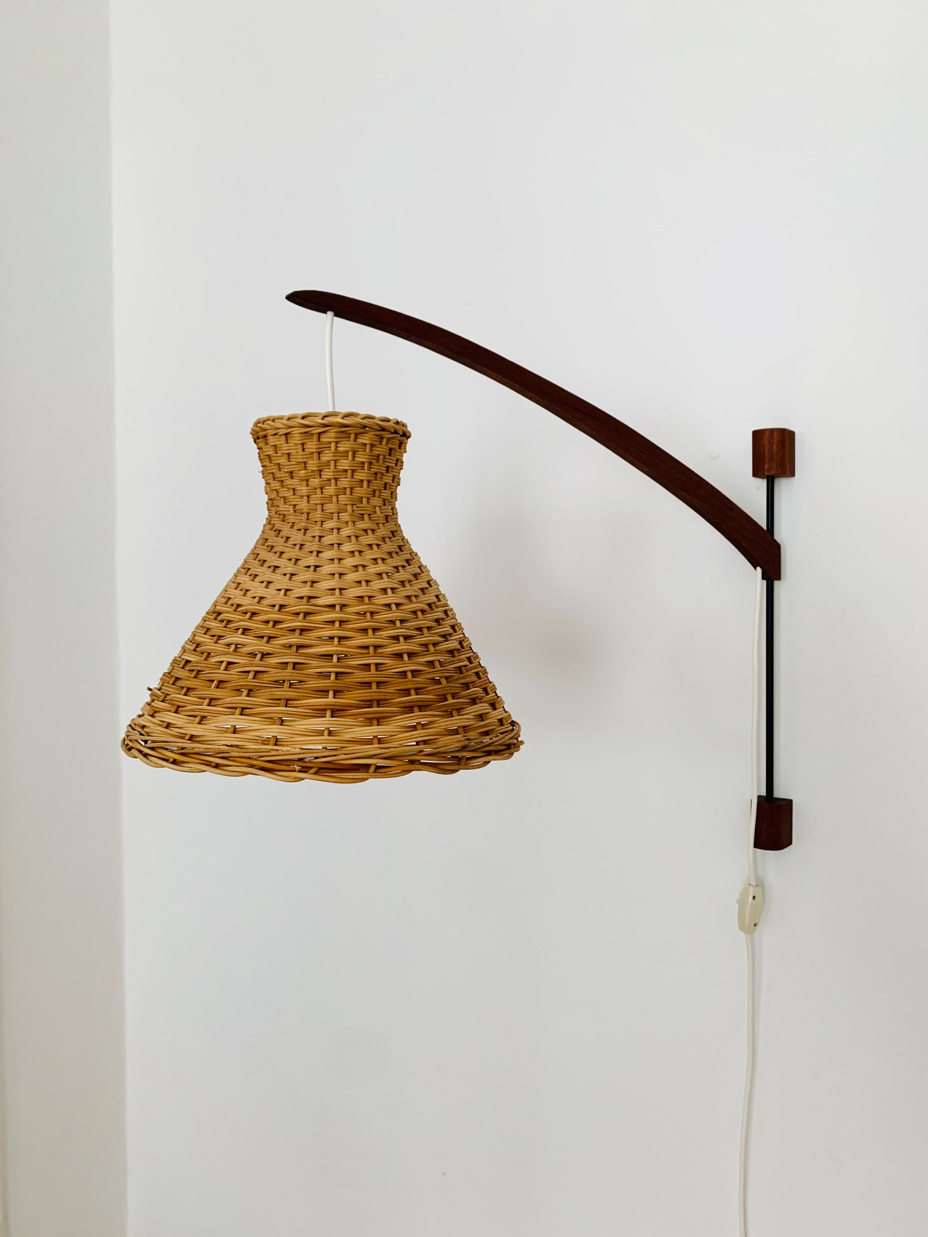 Wonderful Danish teak wall lamp from the 1960s.
Great and exceptionally minimalistic design with a fantastically elegant look.
Very nice swiveling teak arm.
The lampshade creates a spectacular play of light and creates a very cozy