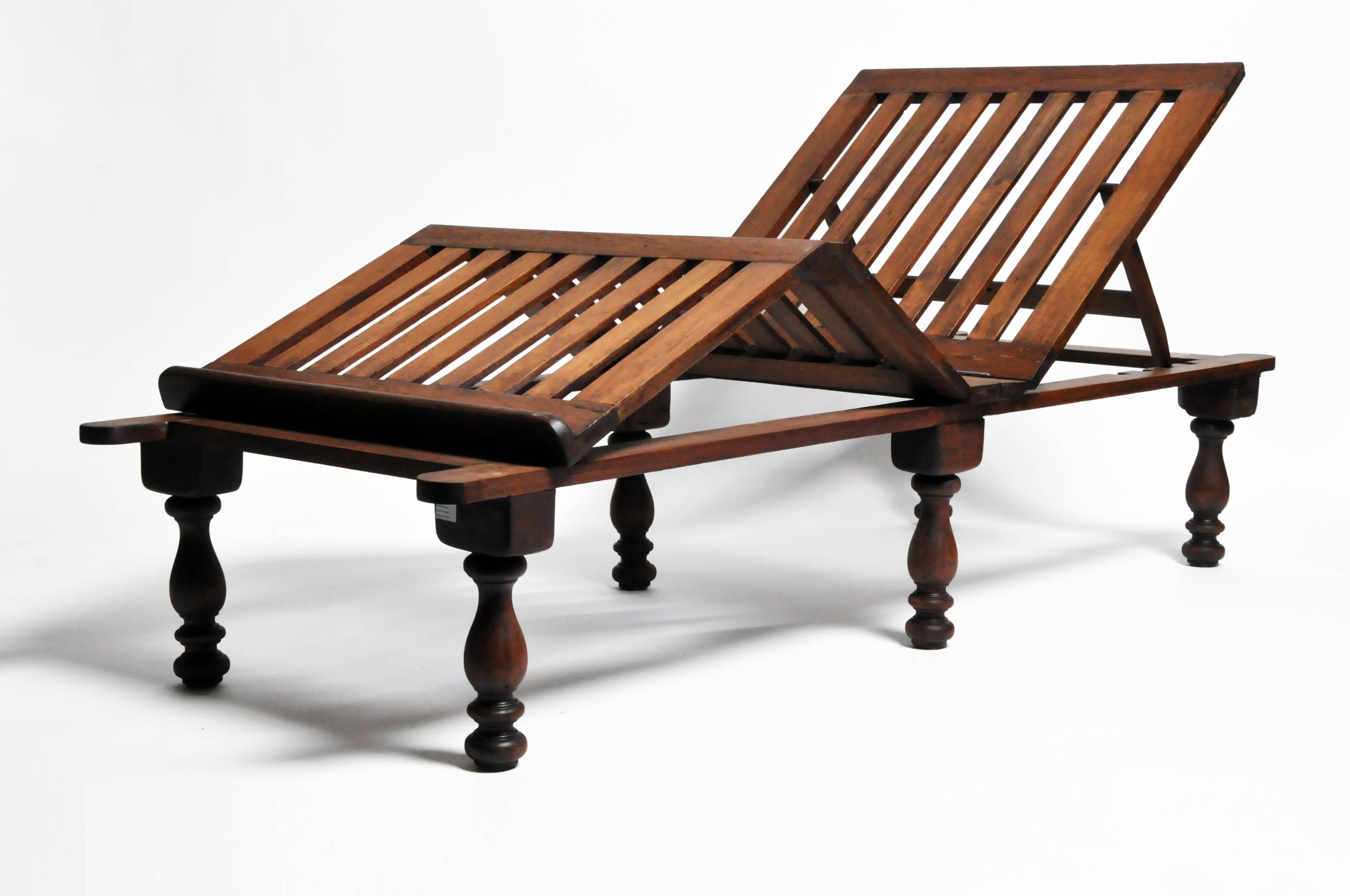This handsome day bed is from India and was made from teak wood. The day bed resembles a reclining beach chair and is adjustable for comfort. Solid and sturdy.