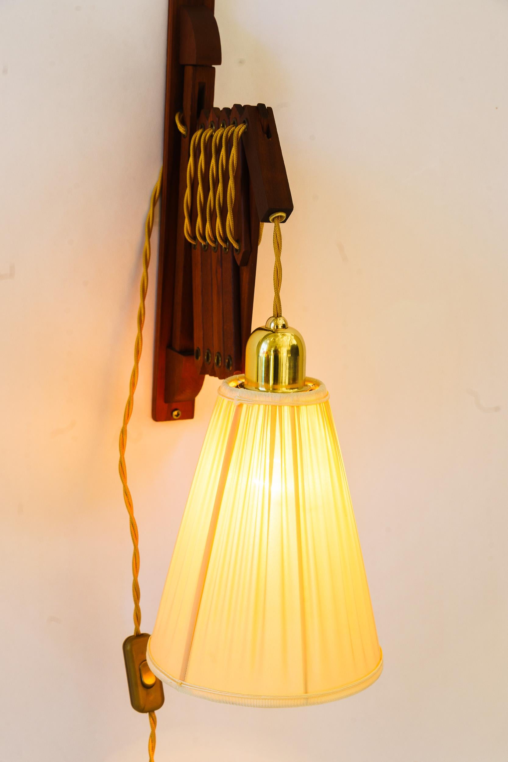 Fabric Adjustable teakwood wall lamp with fabric shade denmark around 1960s For Sale