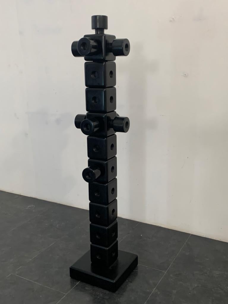 Totem shaped coat rack composed of full height holes and four sides with attached female screw. Accessories with male and female screw to insert and overlap. Material solid wood black lacquered.