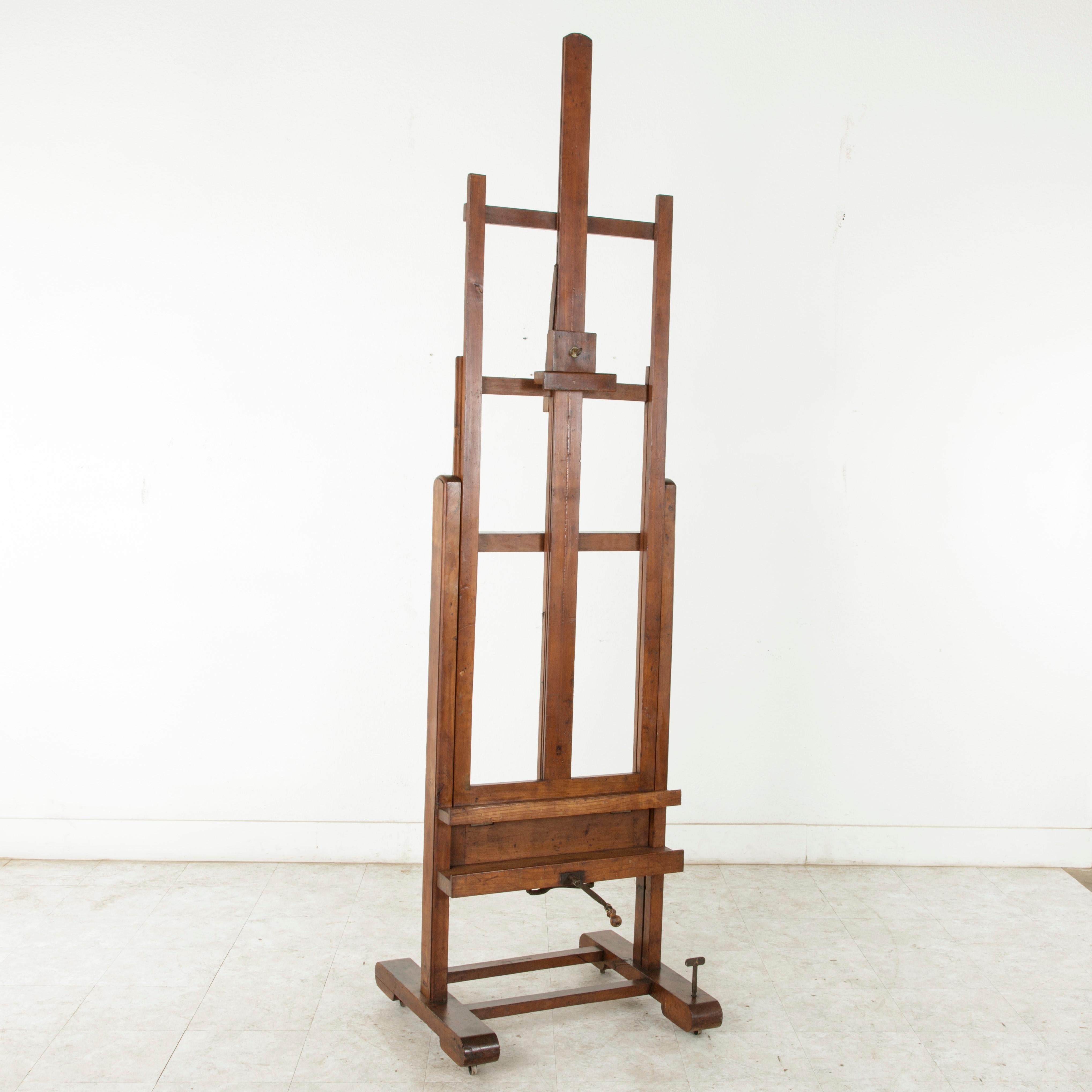 This very large cherrywood floor easel from the late 19th century was originally used in a French gallery for exhibiting art. An extraordinary find, this easel features a double mechanism, with a crank allowing for the height to be adjustable, and a