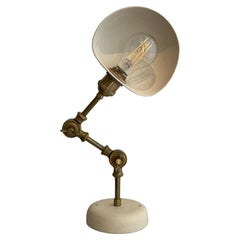 Adjustable wall light with brass arm, matte off-white ceramic pieces
