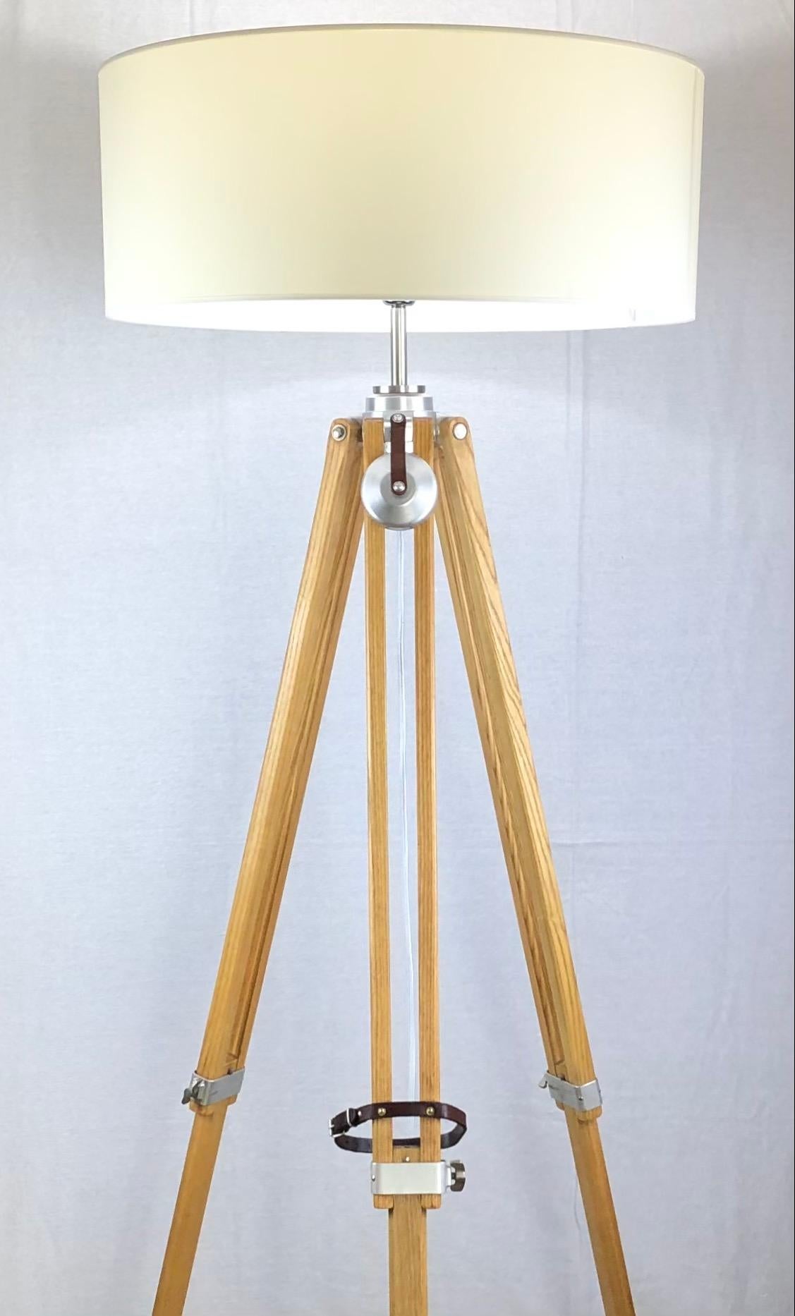 An original vintage surveyor or photographer's tripod converted into a floor lamp. This important iconic piece of Swiss history makes a beautiful floor lamp and embodies all the classical elements of the era. Made by and stamped Kern Aarau,