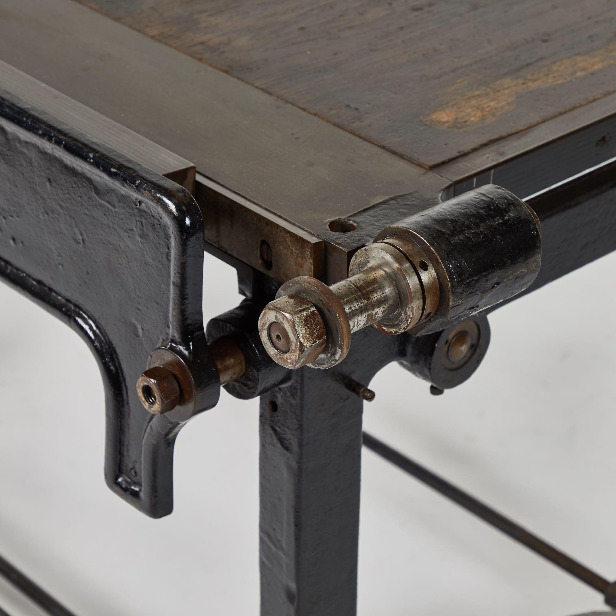 An adjusting drafting table in iron with mahogany top, originating in France, circa 1900.