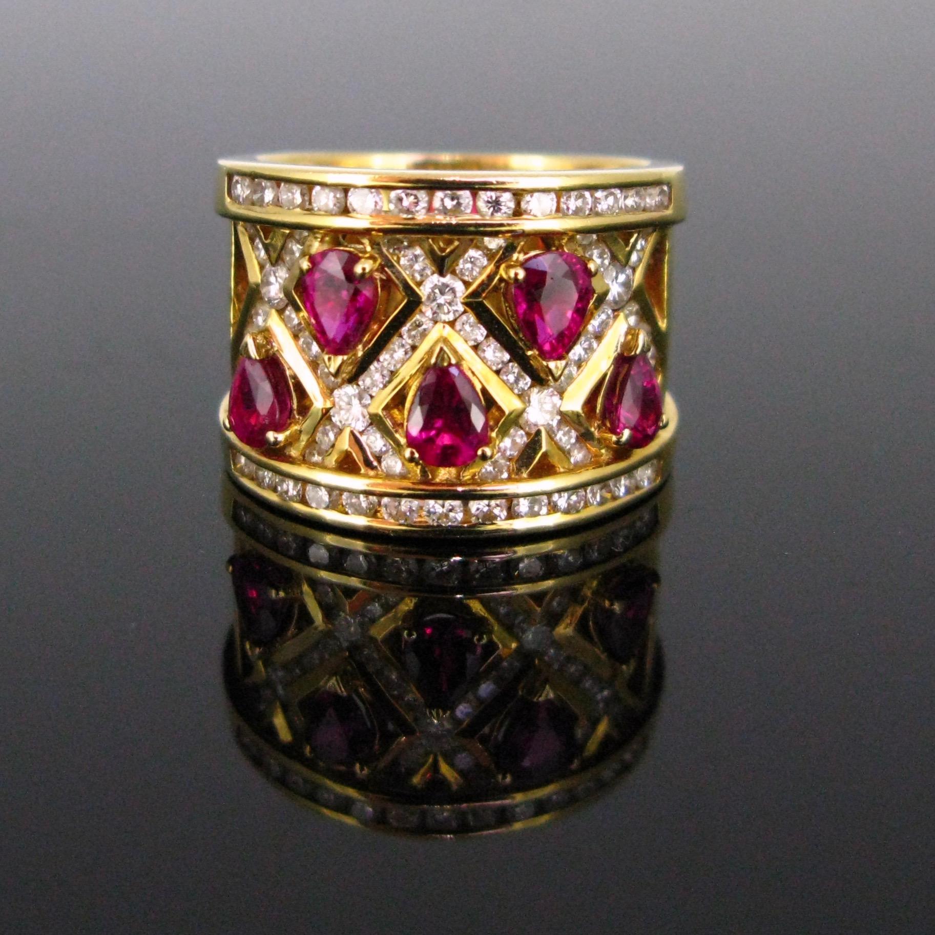 This ring is made in 18kt yellow gold. It is set with 5 pear cut rubies on a crosspiece design adorned with brilliant cut diamonds. The ring is signed Adler inside the ring band. The gold is smooth and shiny, and the ring is very pleasant to wear