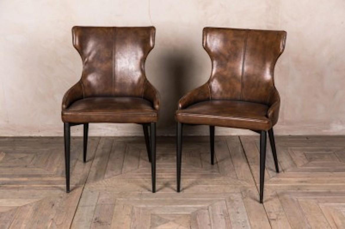 A fine Admiral wingback dining chair range, 20th century.

These sophisticated wingback dining chairs are perfect for a vintage inspired interior. The ‘Admiral’ chair design features simplistic, elegant stitching and black minimalist tapered legs.
