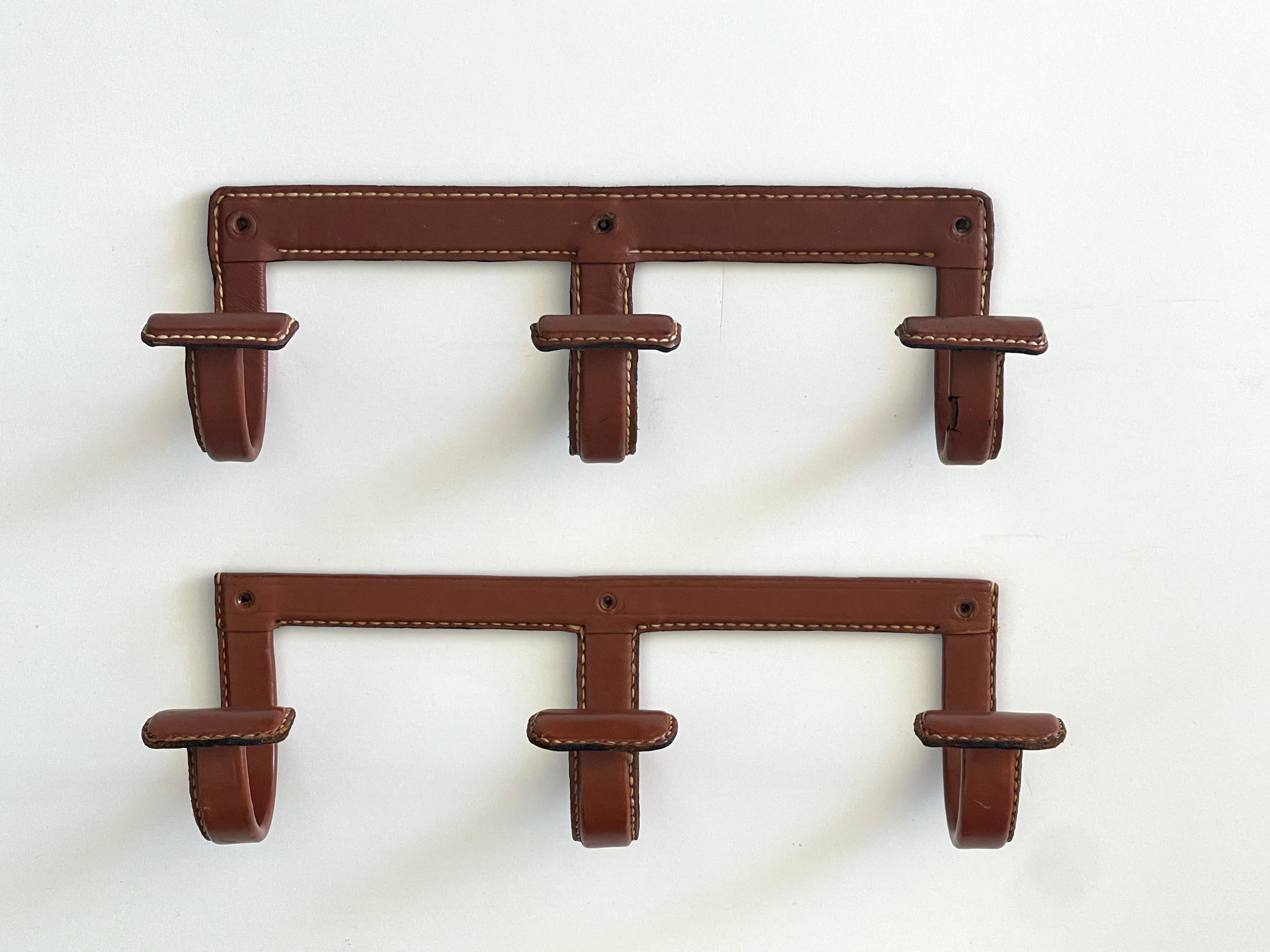 Jacques Adnet camel leather coat hook with 3x hooks and signature contrast stitching. 
Original leather
 - sold individually.