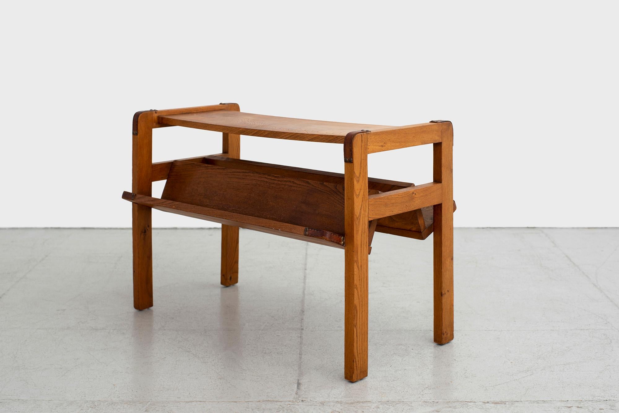 Handsome oak magazine table by Jacques Adnet. Rectangular oak top with inverted 