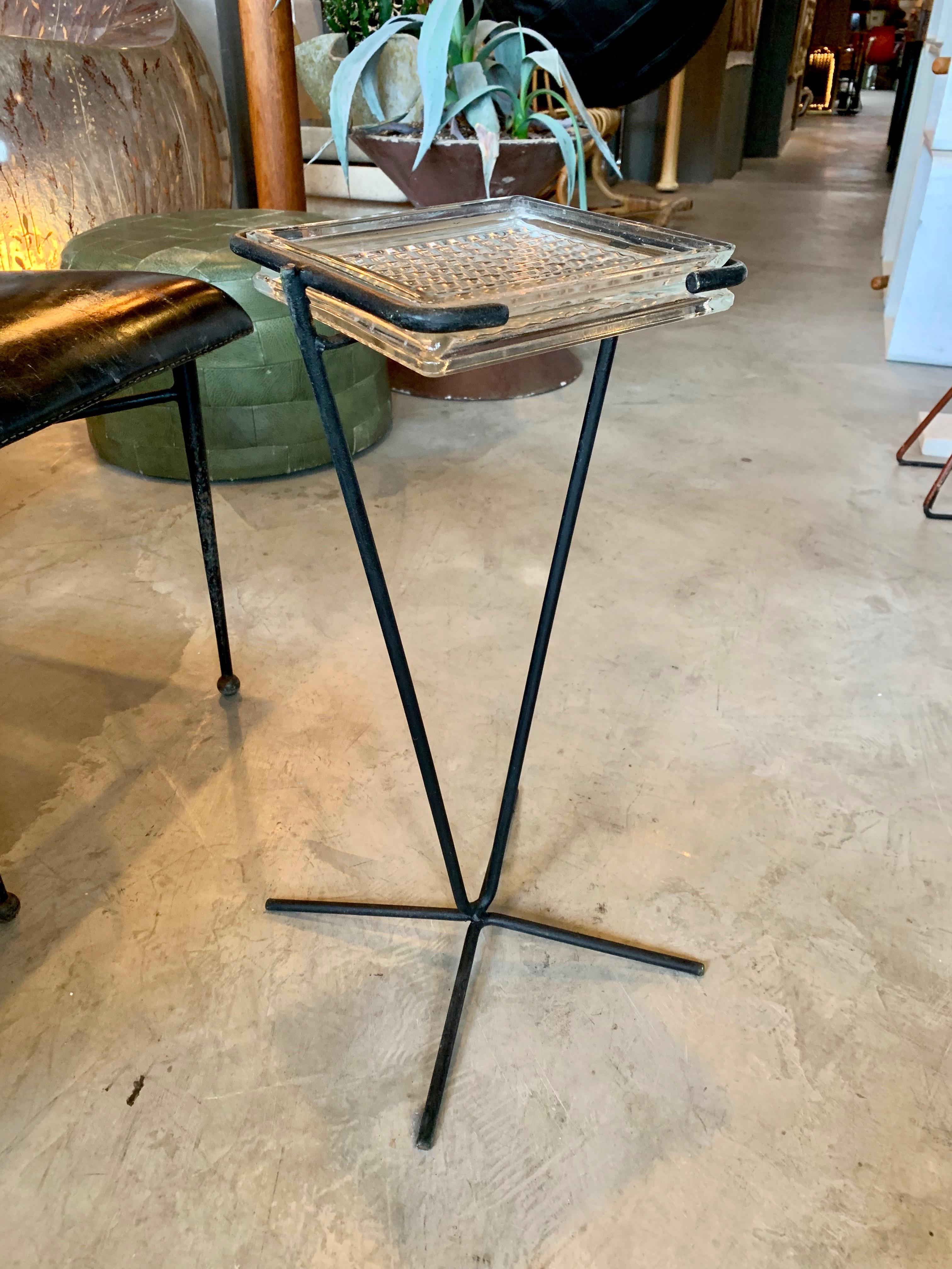 Handsome iron and glass catchall in the style of Jacques Adnet. Sculptural iron frame with tubular legs. Glass dish floats inside. Perfect vide poche/ catchall. Great for keys by the door.