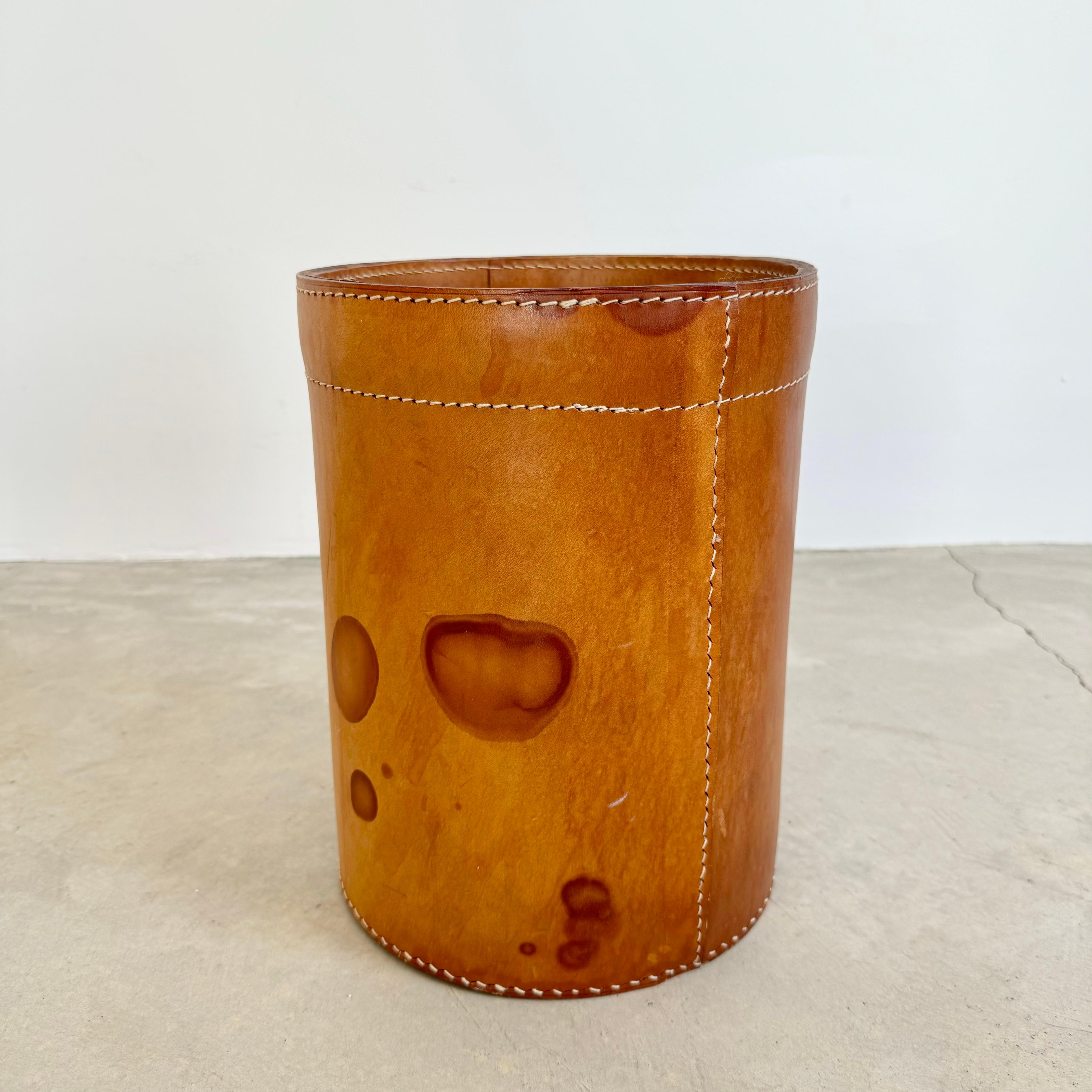 Handsome large saddle leather waste bin in the style of Jacques Adnet. Circa 1950s. Extremely thick cowhide with great color and age. Wear as shown. Great patina. Good vintage condition. 2 available. Priced individually.

In our Los Angeles showroom.