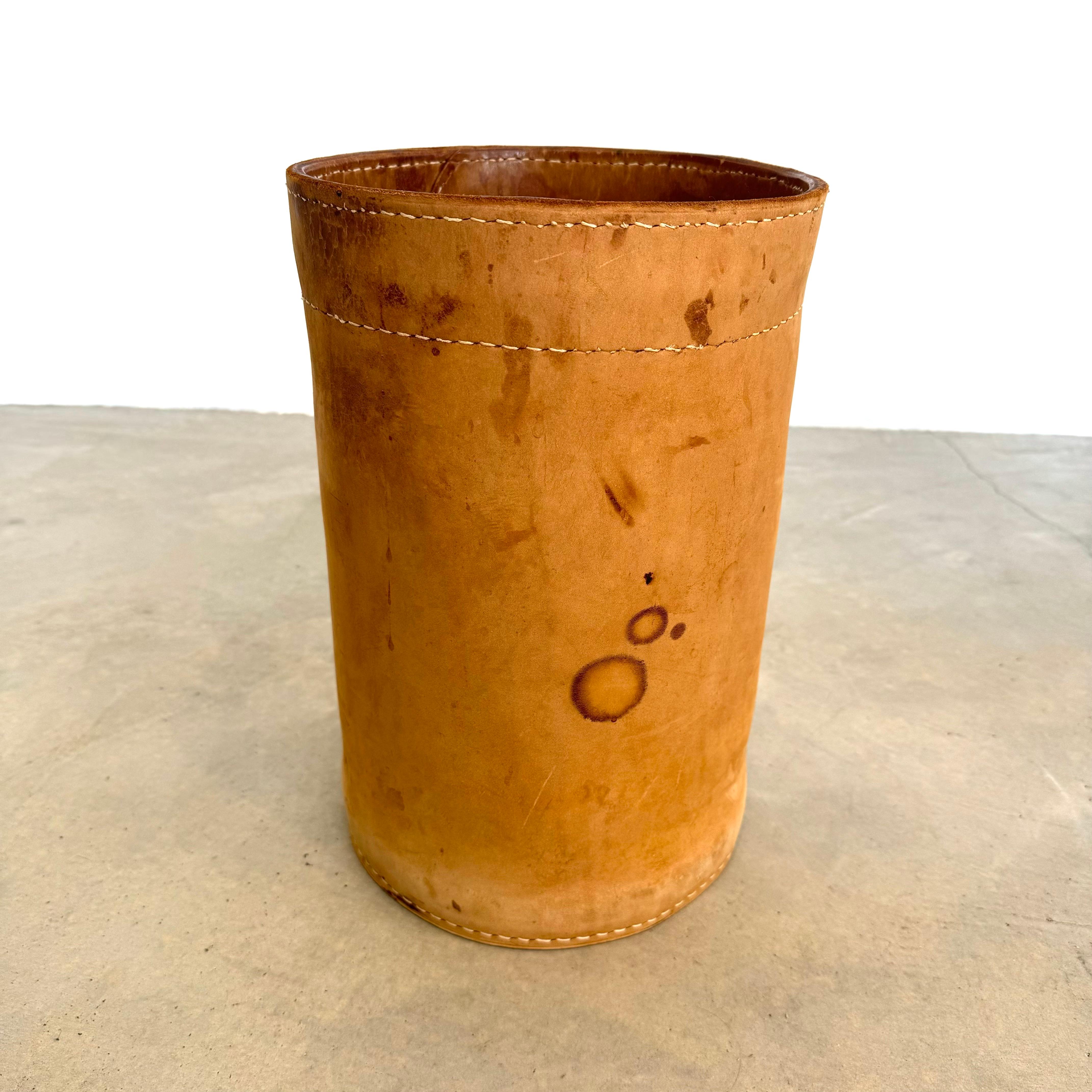Handsome large saddle leather waste bin in the style of Jacques Adnet. Circa 1950s. Extremely thick cowhide with great nubuck finish. Wear as shown. Great patina. Good vintage condition. Priced individually.

In our Los Angeles showroom.