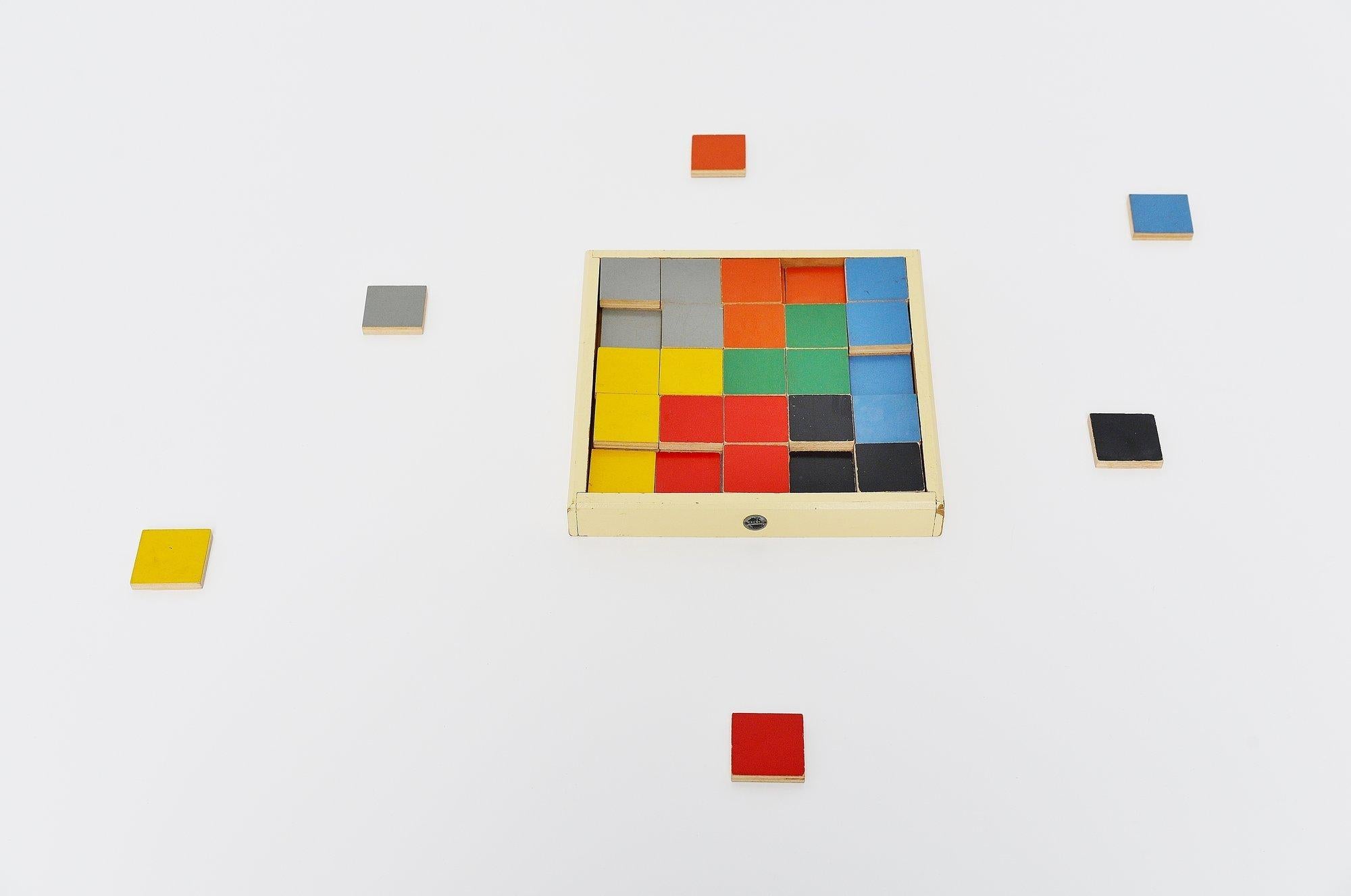 Very rare puzzle tiles box model 259. designed by Ko Verzuu for Ado Holland in 1939. Ado means Arbeid door onvolwaardigen, translated; labor by incapacitated, which makes this an even more special piece. Toys by Ado are being highly collected at the