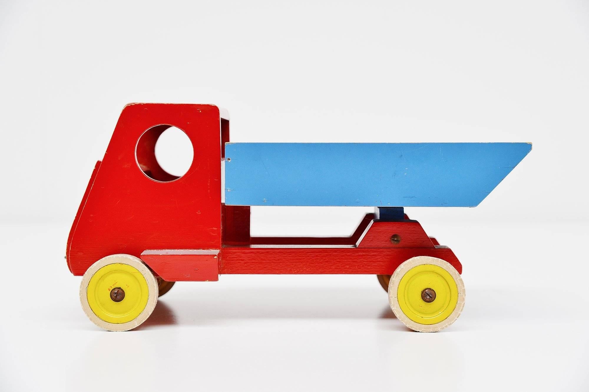 Very nice toy tilt truck designed by Ko Verzuu for Ado Holland in 1951. Ado means Arbeid door onvolwaardigen, translated; labor by incapacitated, which makes this an even more special piece. Toys by Ado are being highly collected at the moment, even