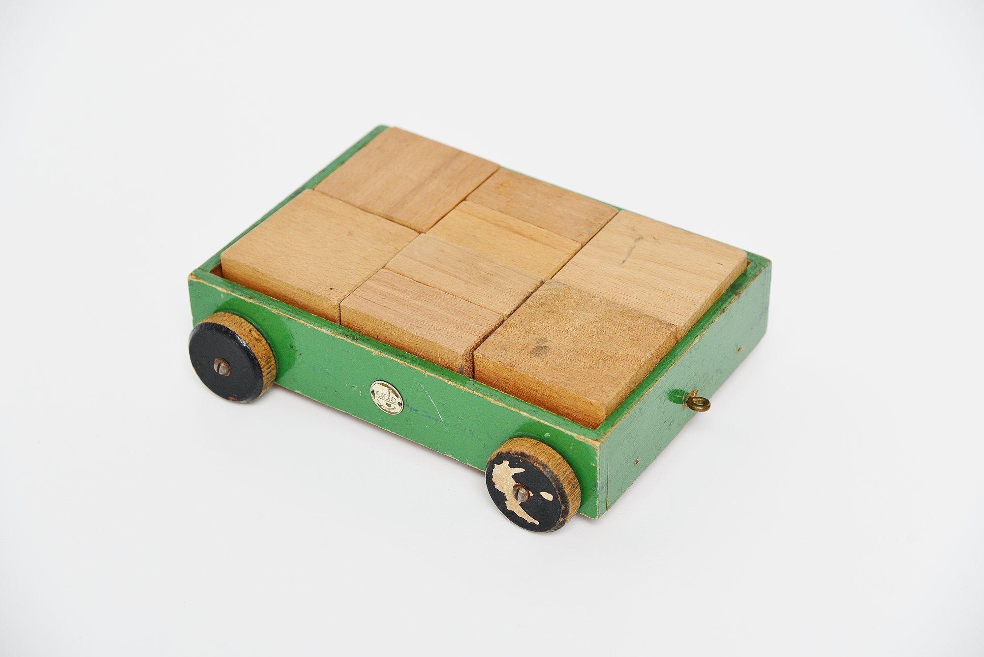 Very nice decorative wooden toy cube car model 646, designed by Ko Verzuu for Ado Holland in the 1937.  Ado means Arbeid door onvolwaardigen, translated; labor by incapacitated, which makes this an even more special piece. Toys by Ado are being
