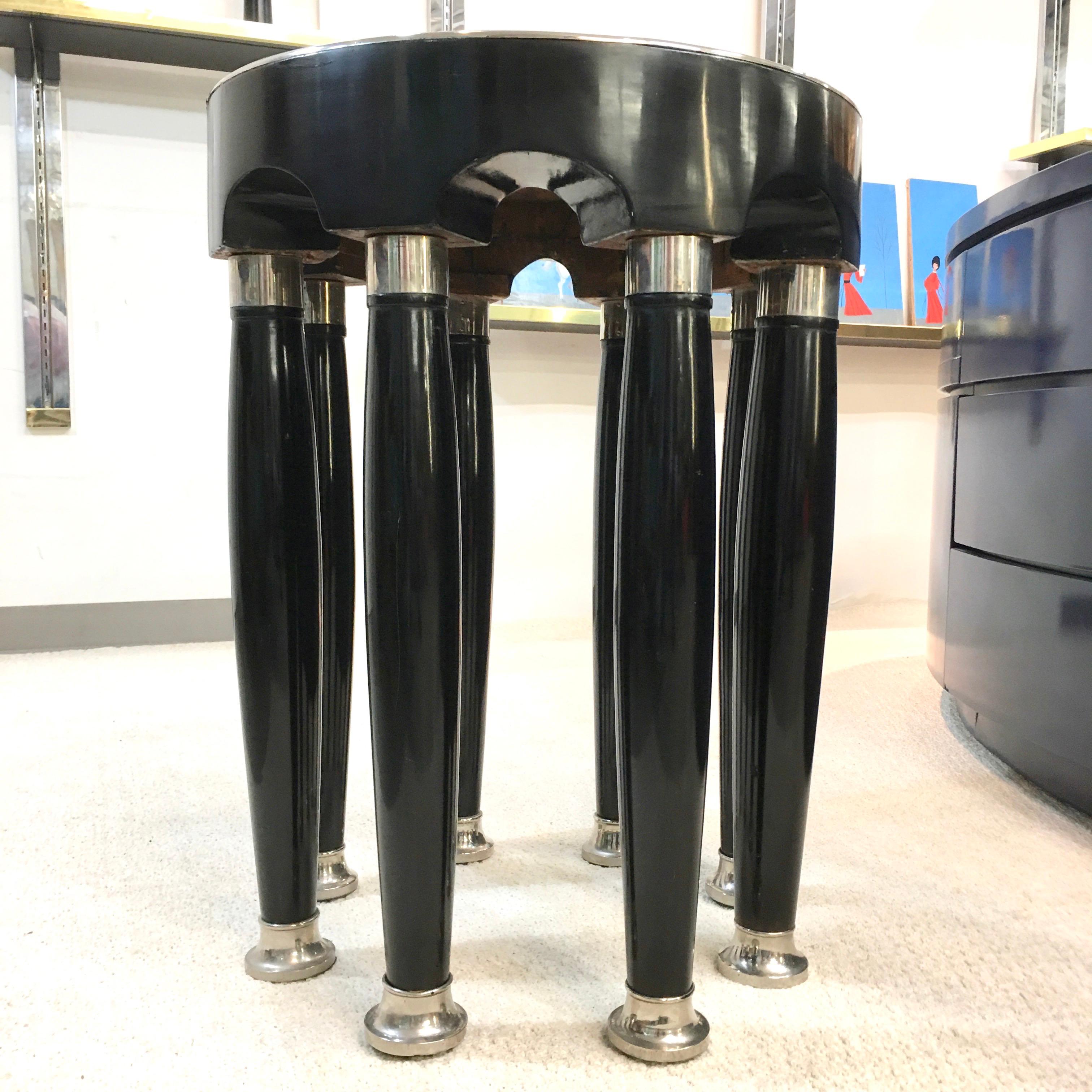 An eight-columned avant-garde round table attributed to Adolf Loos and executed by the Viennese firm of Friedrich Otto Schmidt. 
Polished black enamel over hardwood and veneer with polished chrome cuffs and sabots.
Adolf Loos used variations of
