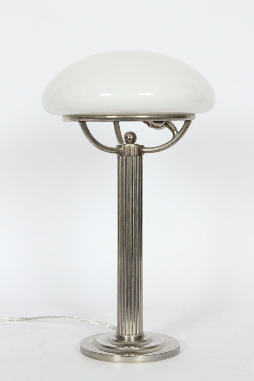 Viennese Secessionist Adolf Loos, Villa Steiner nickel table lamp, Circa 2010. Featuring a Nickel plated Brass fluted stem, rim and tiered (6D) base. Round rim anchors separate domed (10D x 3.5H) opaline glass shade. 13.5H to top of rim. With cord