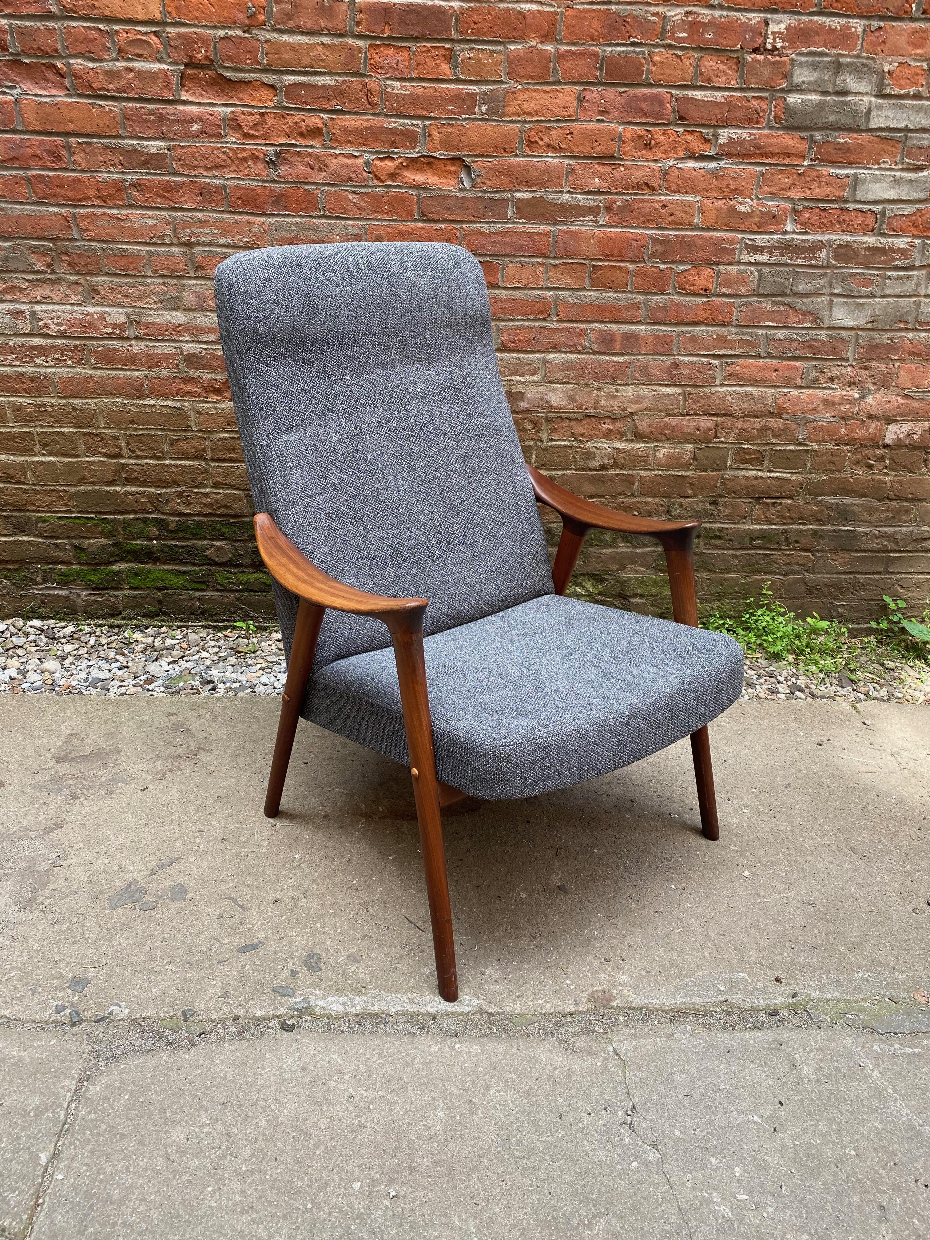 Adolf Rastad and Rolf Relling solid teak and upholstered armchair. Cozy and comfortable high back lounge chair. Great lines and profile, circa 1960-1965. Structurally sound and sturdy. Reupholstered in a nubby gray fabric. Original finish with some