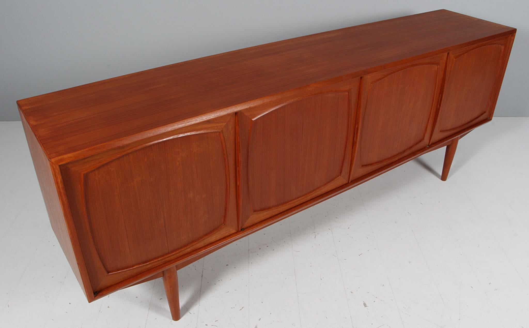 Scandinavian Modern teak credenza or sideboard by Adolf Relling & Rolf Rastad for Bahus, Norway 1960s.

This Scandinavian Modern sideboard form Norway is entirely made of teak. It has 4 doors with beautiful solid teak inlays. Inside the cabinet you