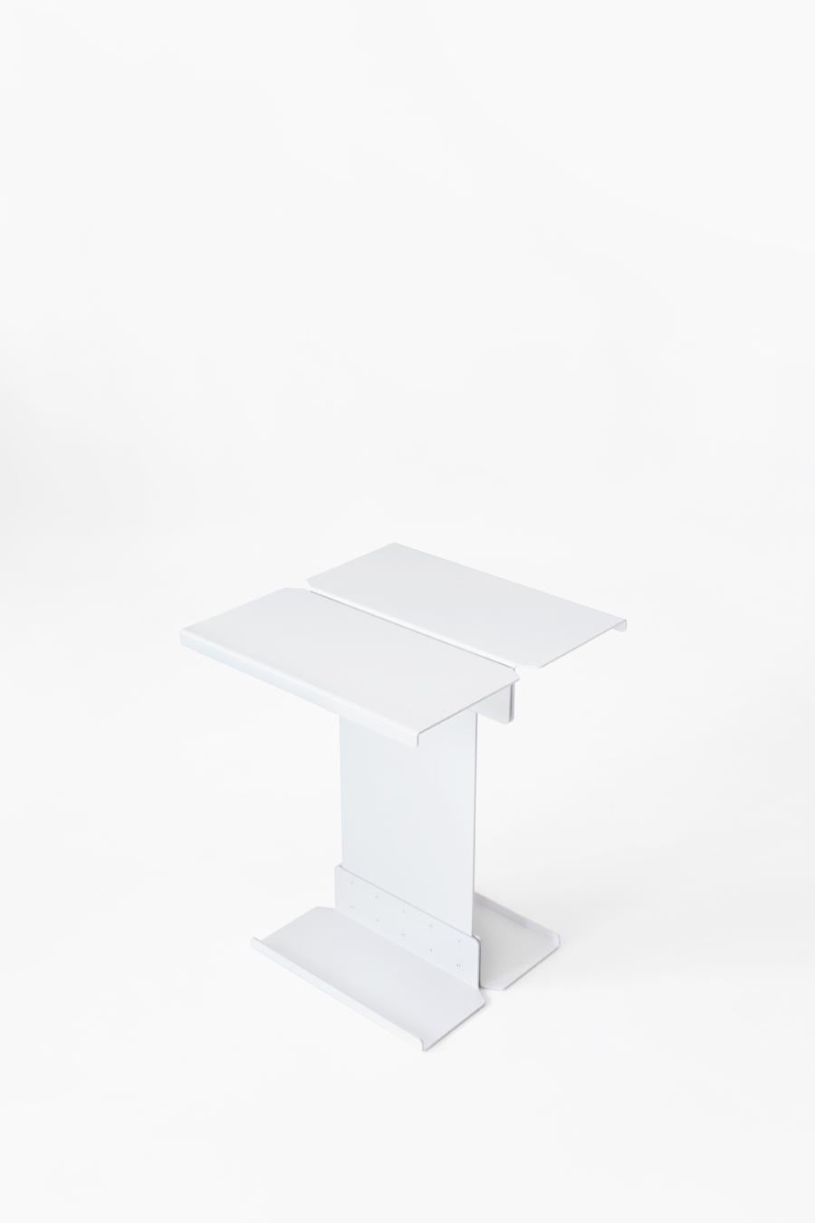Five is a side table made in iron sheet and aluminum, and finished in matte paint. It’s a rational and futuristic design; it consists of five pieces joined together with rivets that give the table an industrial feel. This design reflects on how