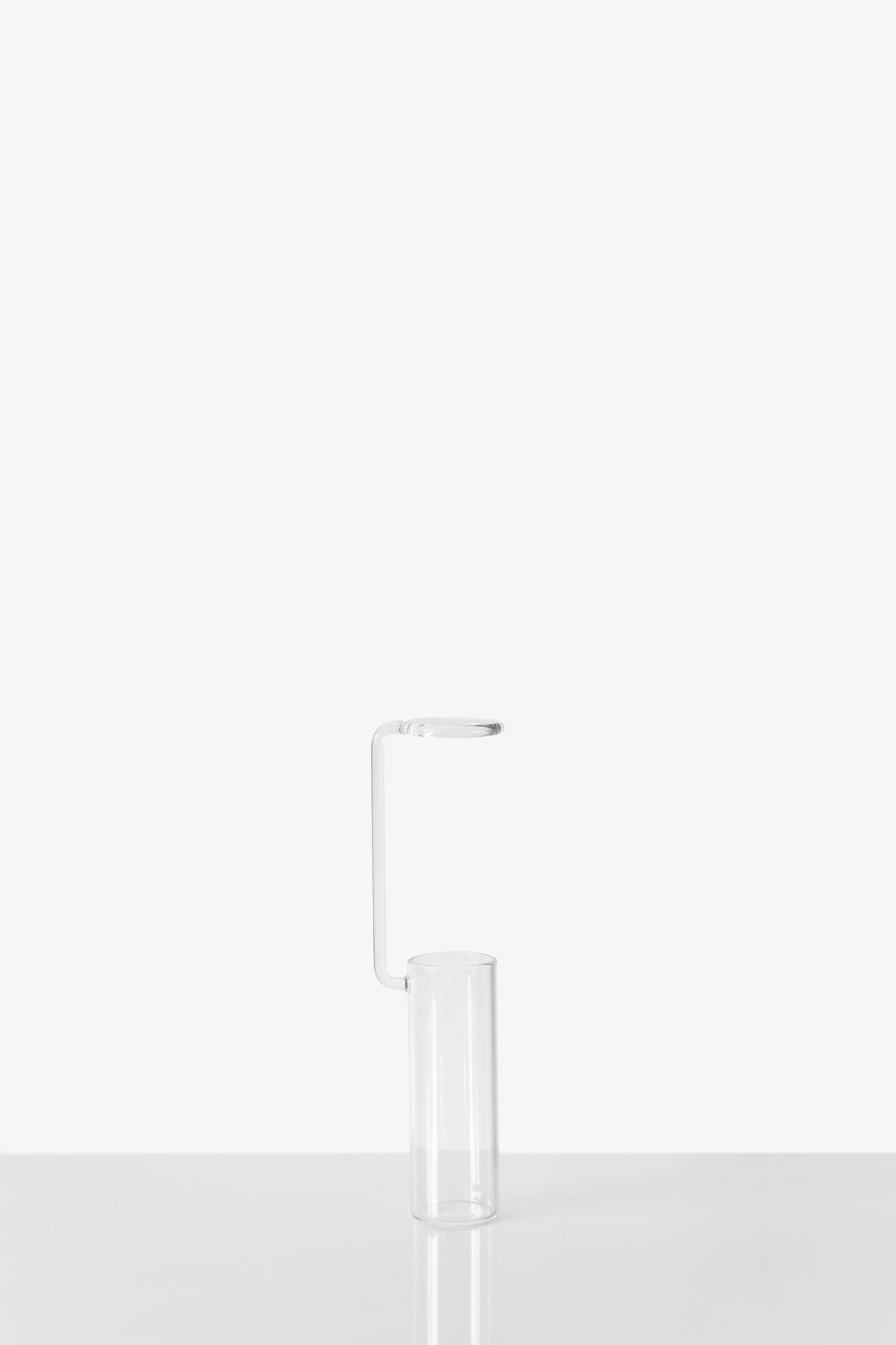 Vase designed by Adolfo Abejon

Measures: 63 × 42 × 232 mm (L × W × H). Glass.

We offer free worldwide shipping for this piece.

Melancholia is a series of handmade glass vases. Inspired by laboratory test tubes, they turn flowers into study