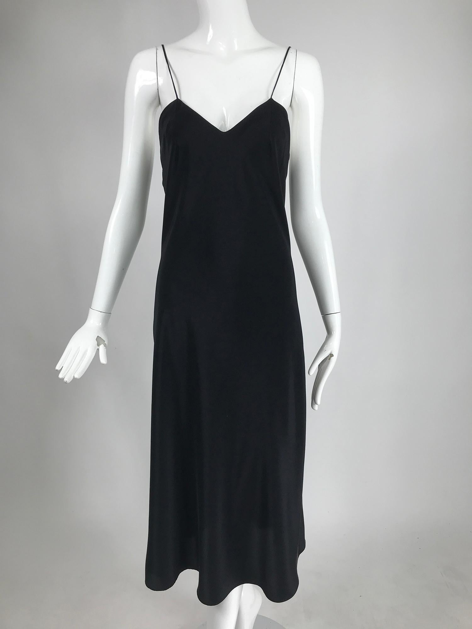 Adolfo black silk slip dress and chiffon cape from the 1970s. Amazing two piece set, the black slip dress is silk satin, bias cut with thin spaghetti straps. The dress is unlined with facings at the neckline. The matching cape is sheer silk chiffon,