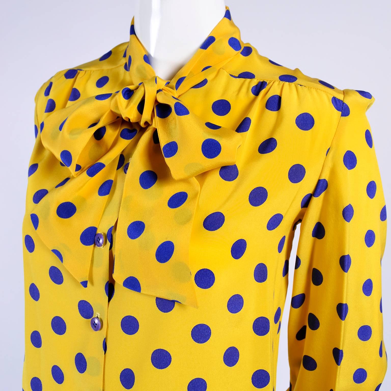 This beautiful silk Adolfo blouse came from an Adolfo collector who owned many of his pieces in the 1970's and 1980's.  We have several of her suits on 1stdibs right now.  This blouse is in yellow silk with pretty blue polka dots and it has an