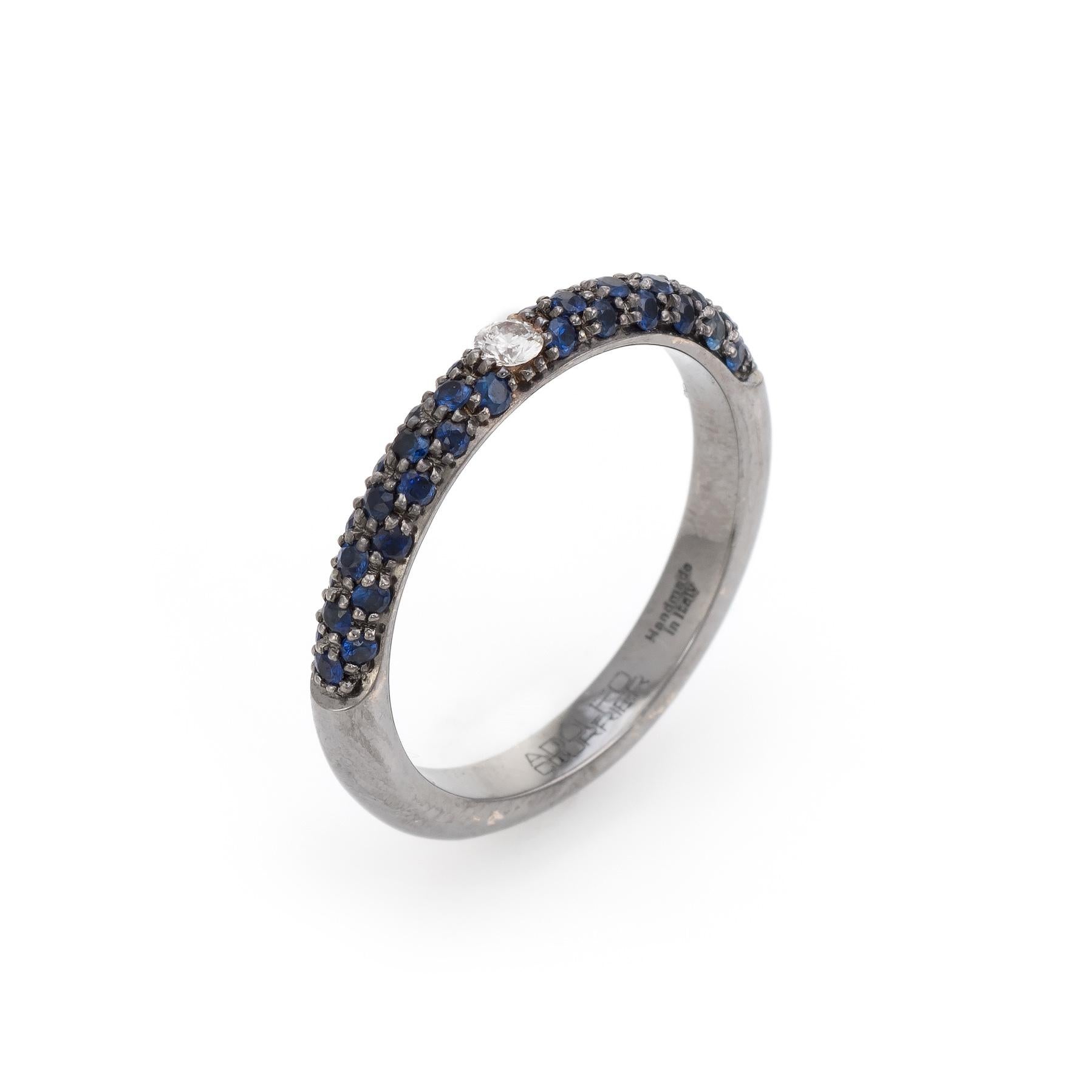 Elegant Adolfo Courrier stacking ring, crafted in 18 karat blackened white gold. 

One estimated 0.11 carat round brilliant cut diamond is set into the band (estimated at H-I color and VS2 clarity), accented with an estimated 0.71 carats of blue