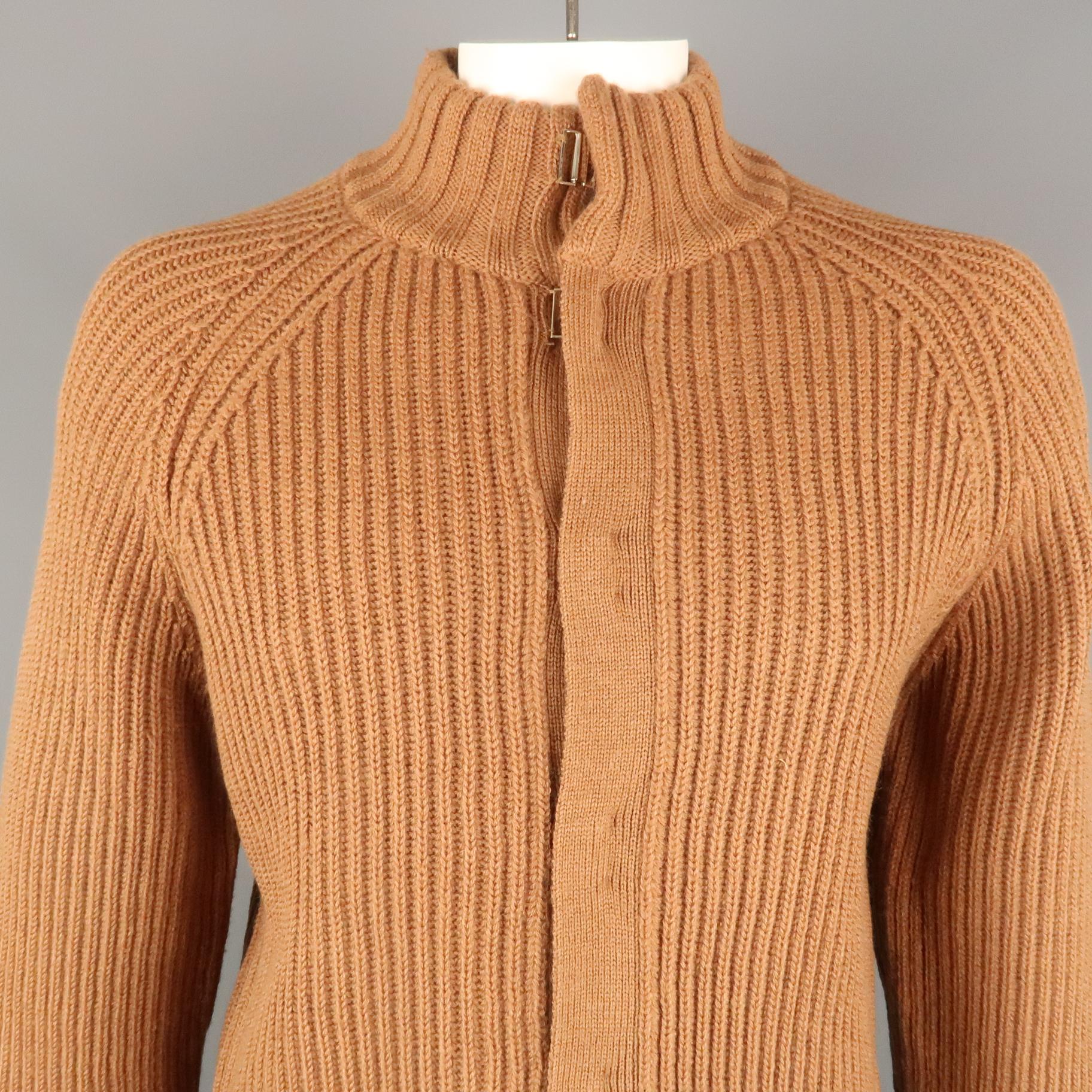 ADOLFO DOMINGUEZ cardigan comes in a brown knitted wool featuring a high collar style and a hook and eye closure.
 
Excellent Pre-Owned Condition.
Marked: 7
 
Measurements:
 
Shoulder: 17.5 in.
Chest: 46 in.
Sleeve: 31 in.
Length: 30 in.