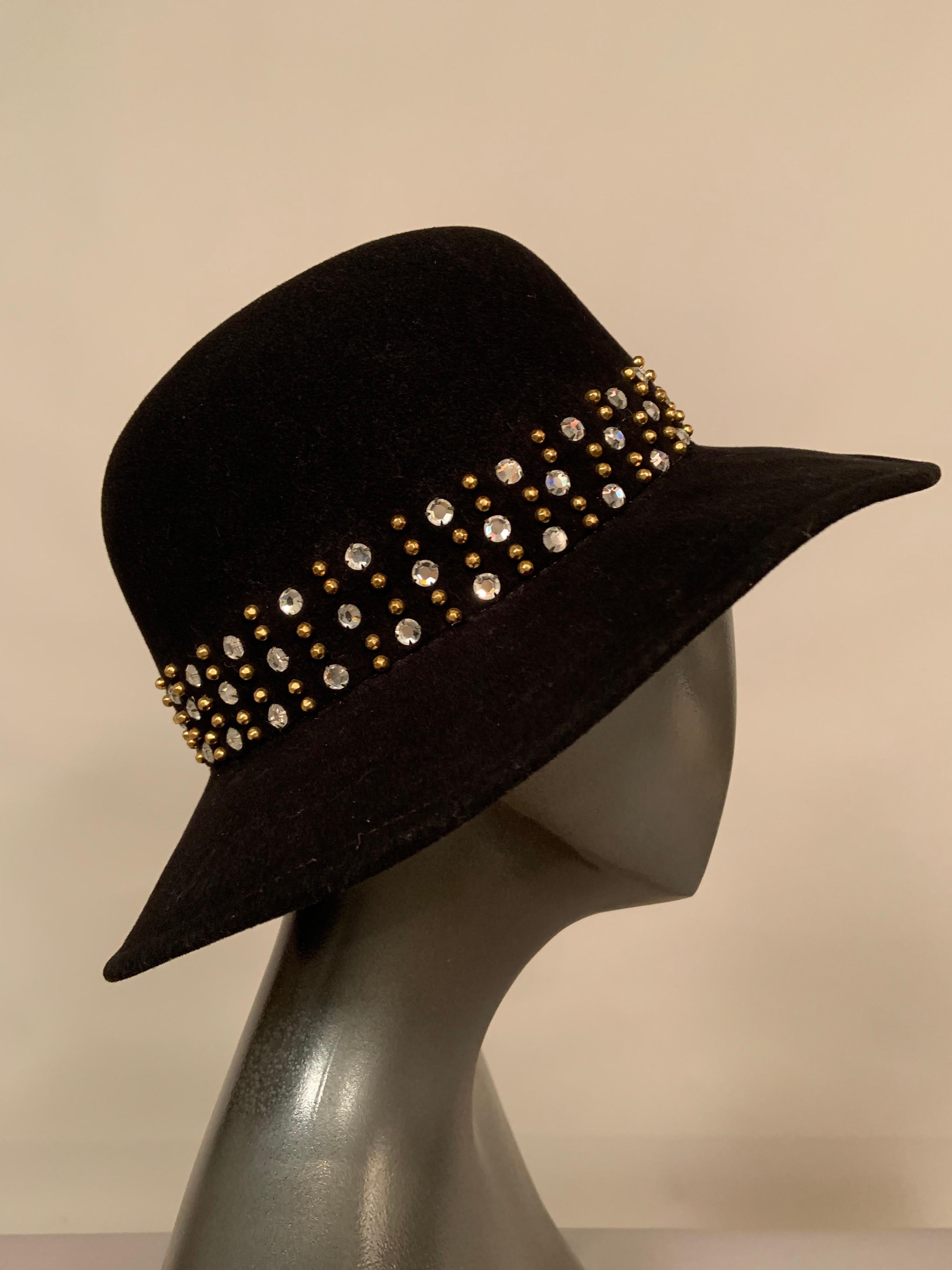 This sparkling hat will add a lot of glamour to any outing or outfit!  The traditional black felt fedora has been transformed by the addition of three rows of prong set rhinestones and faceted brass studs in place of a hatband.  The hat is all wool