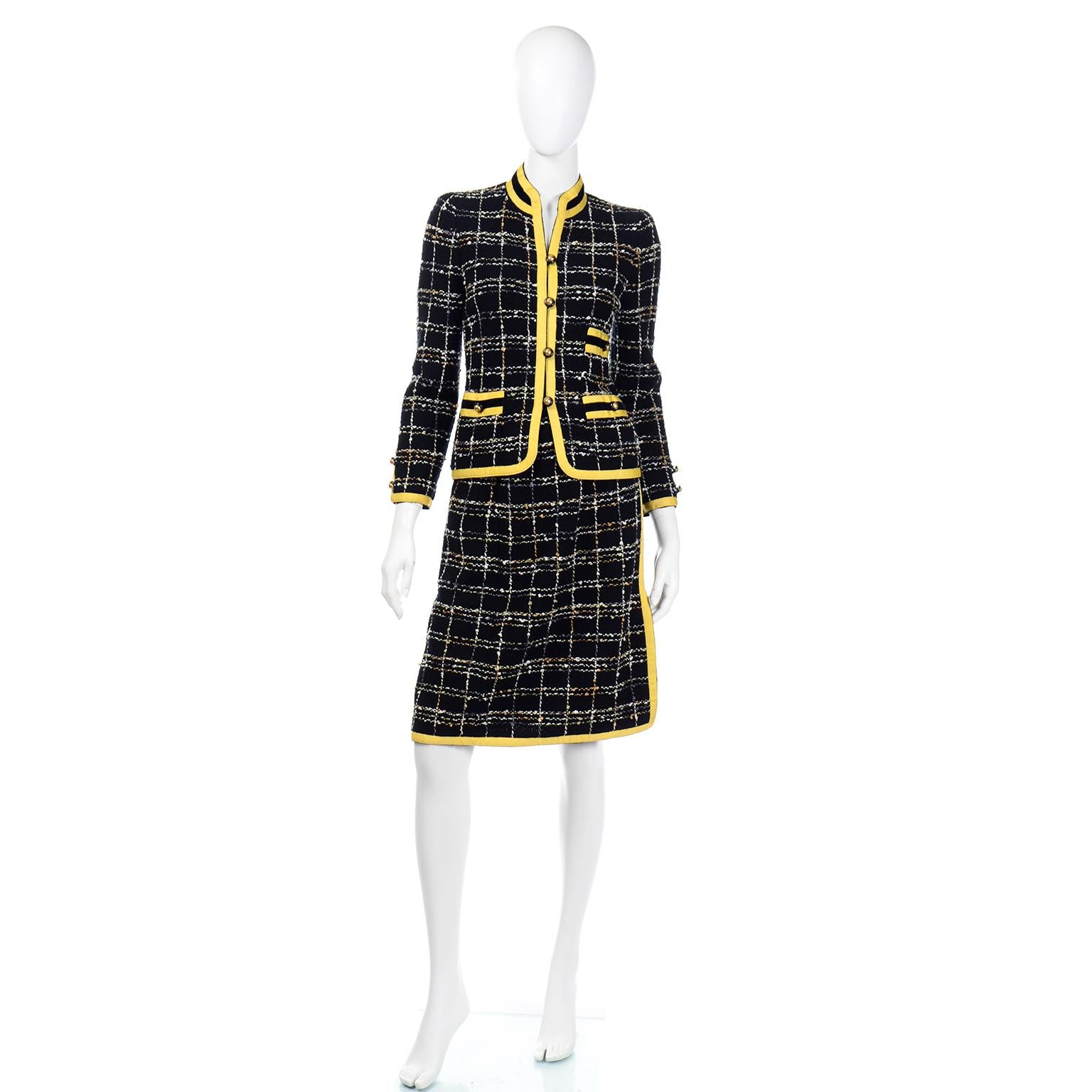 This is a wonderful Adolfo two piece colorful wool knit skirt and jacket suit with pretty bright yellow grosgrain ribbon trim. The trim has black velvet details on the pockets and collar. The jacket closes with pretty gold buttons and it has 3