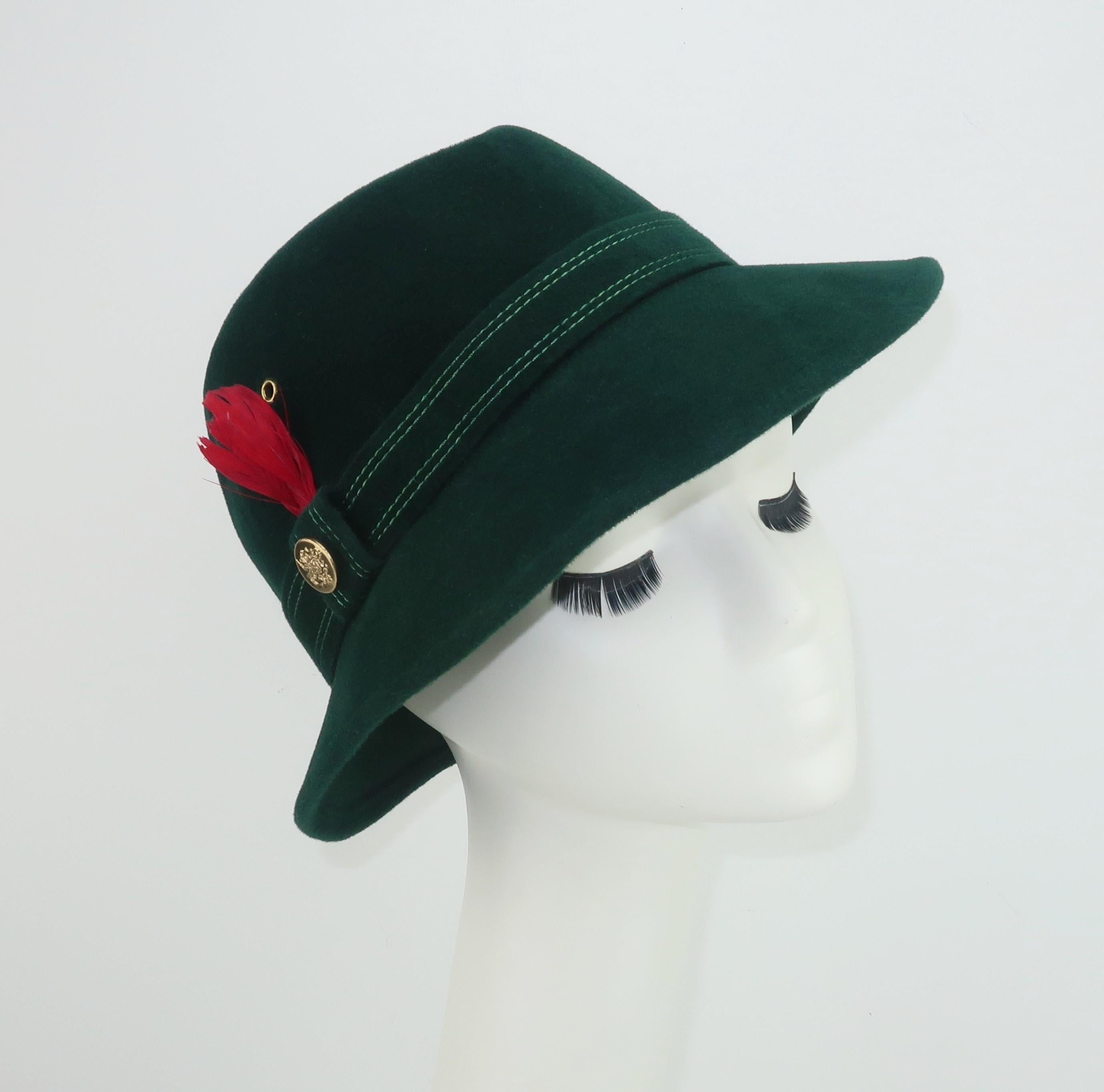 Add a distinctive Alpine touch to your tweeds and woolens with this utra stylish C.1970 Adolfo II green wool felt hat embellished with a red feather and gold button completing the classic Tyrolean look.  A menswear style perfect for accessorizing a