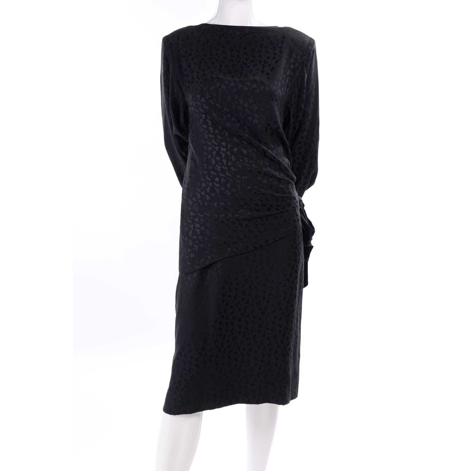 This is a fabulous Adolfo 2 piece black silk dress with pencil skirt and top from the 1980's. The black silk fabric has a beautiful tone on tone leopard print pattern. The top has a dramatic draping tie at the natural waist, draping down over the
