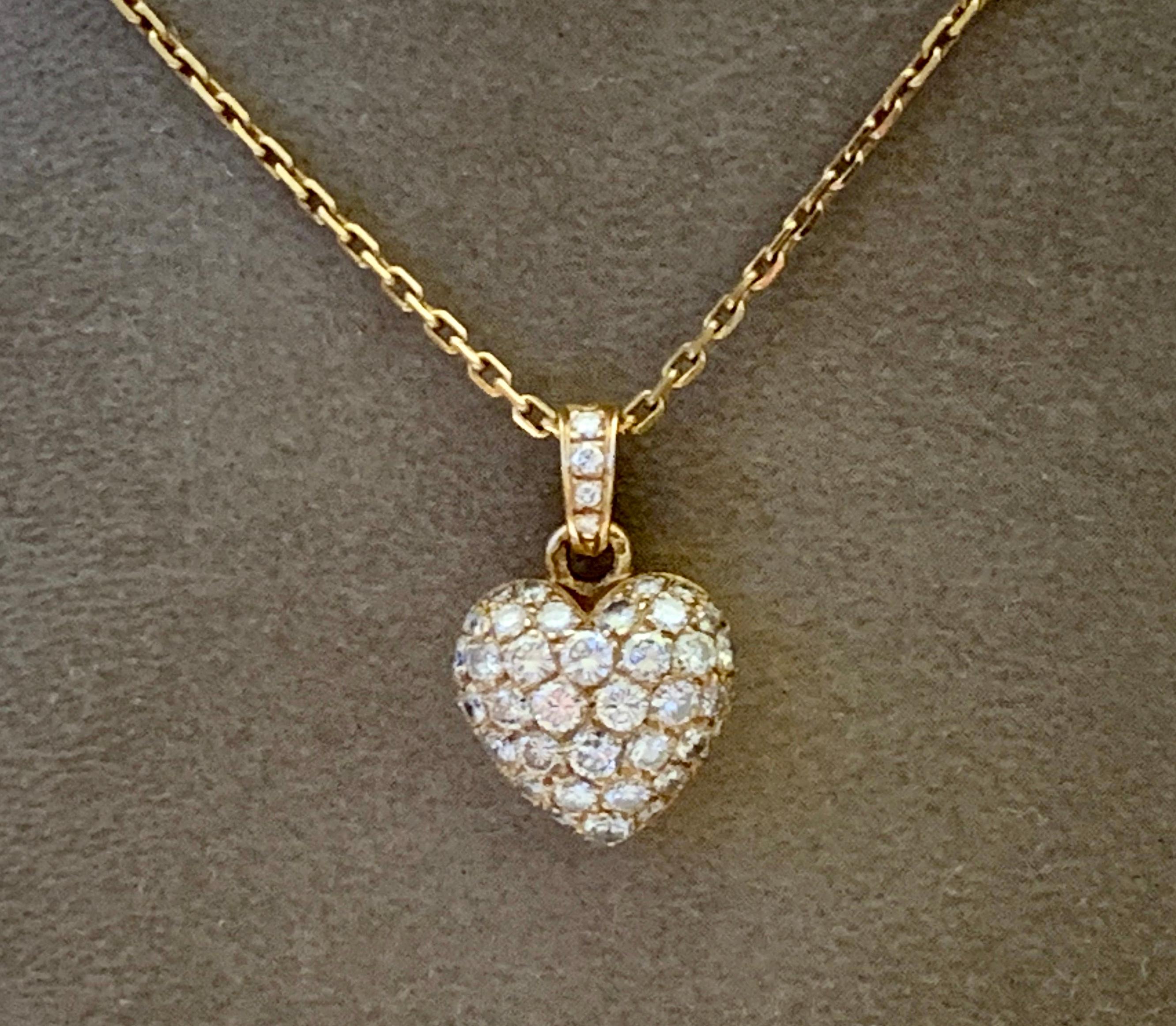 Vintage Cartier Heart Pendant 18K yellow Gold and measuring 2.4 cm X 1.6 cm set with very fine white Round brilliant cut Diamonds totaling approximately 1.40 carats. Suspended from a Cartier 18k yellow Gold link chain with a length of 43 cm. Comes