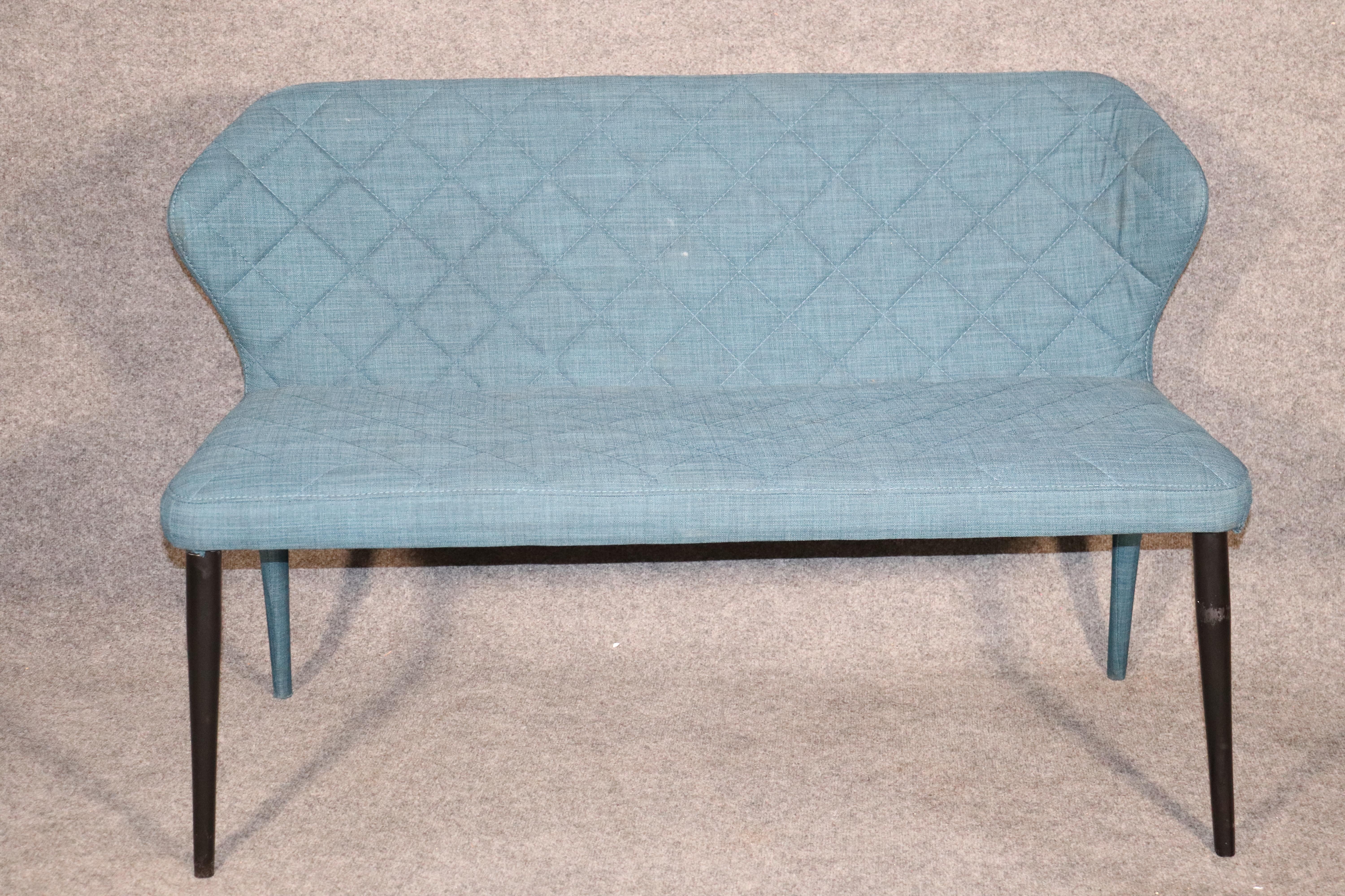 Petite loveseat with curved back and tapered legs. 
Please confirm location.
